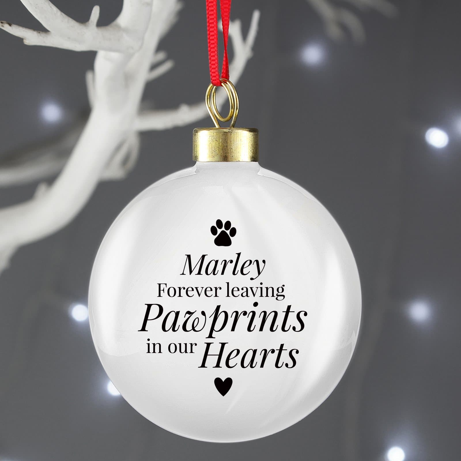 Pet memorial bauble with pawprints wording and a ribbon for hanging