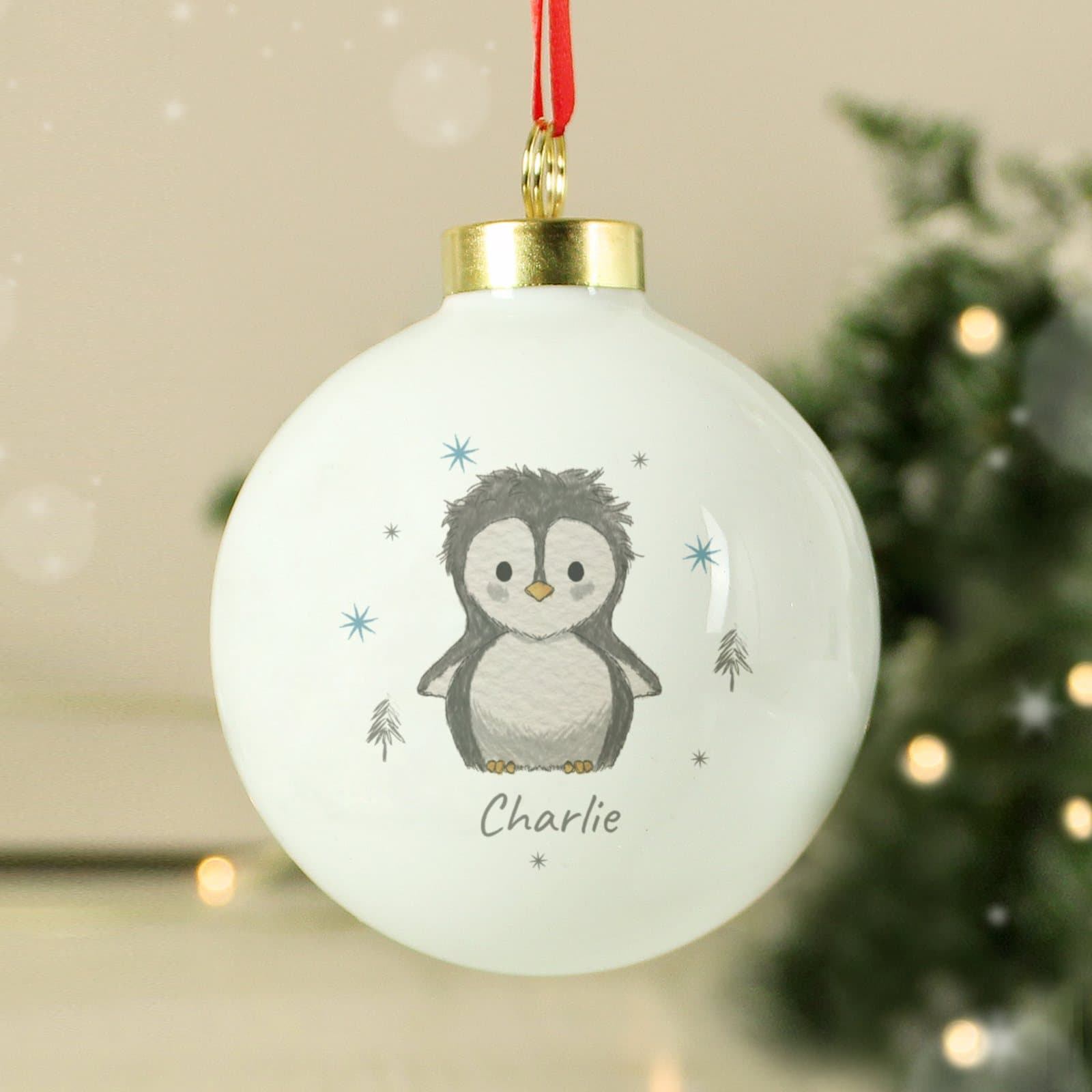 Pebbles the Penguin Christmas bauble with a ribbon for hanging