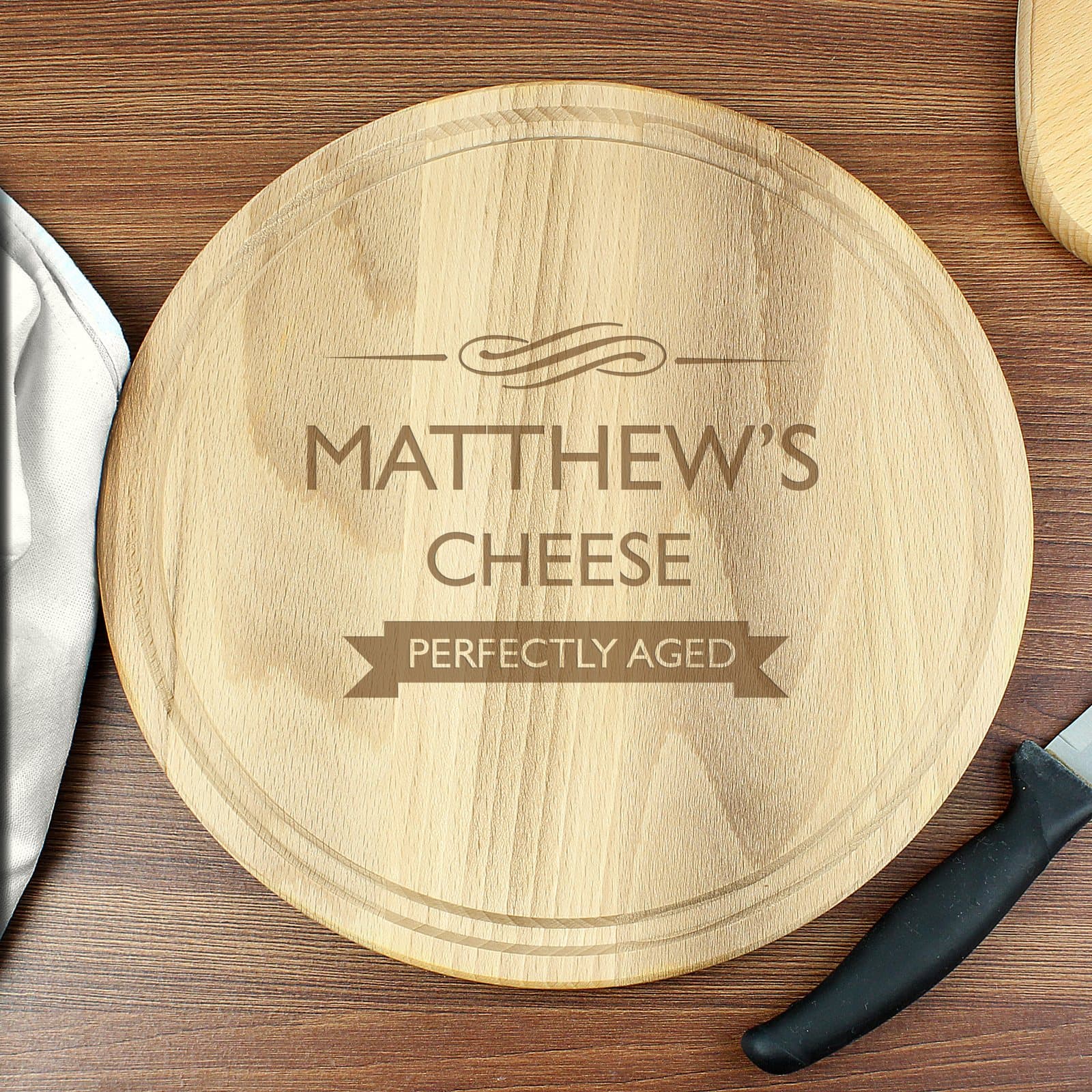 Round wooden chopping board with Perfectly Aged text