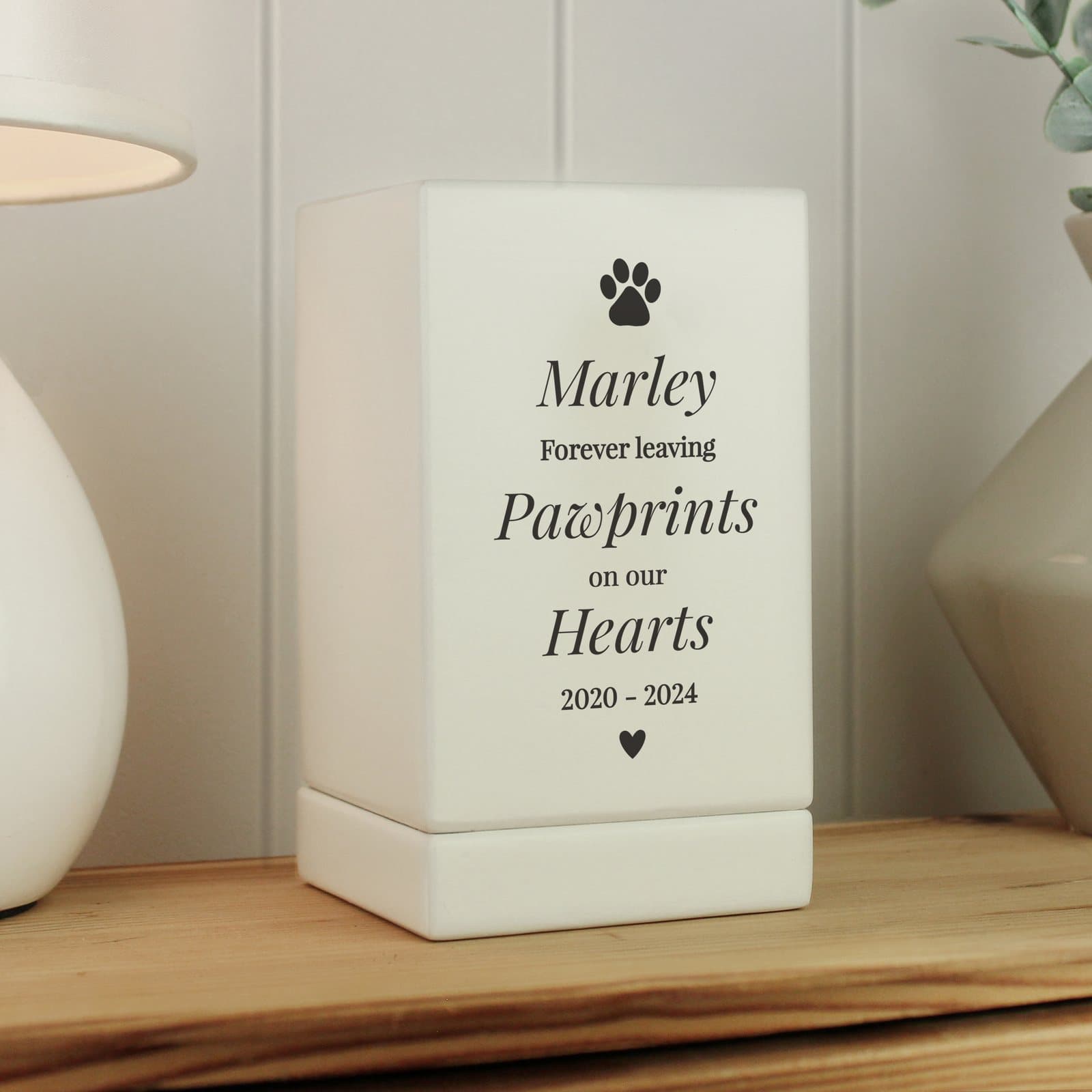 Small wooden pet urn with a paw print design