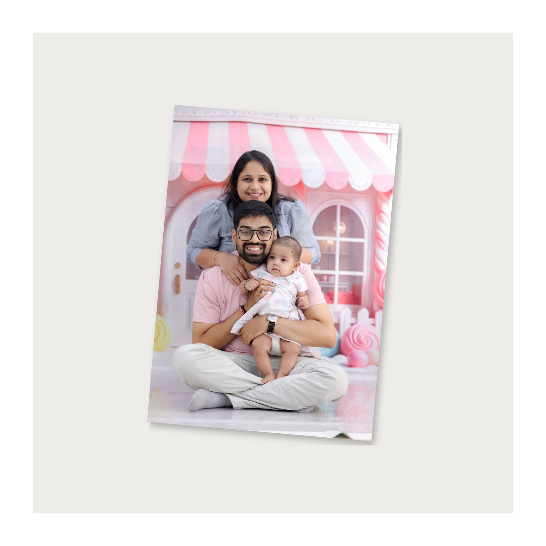 Photo print of a family with a baby lying on a light table