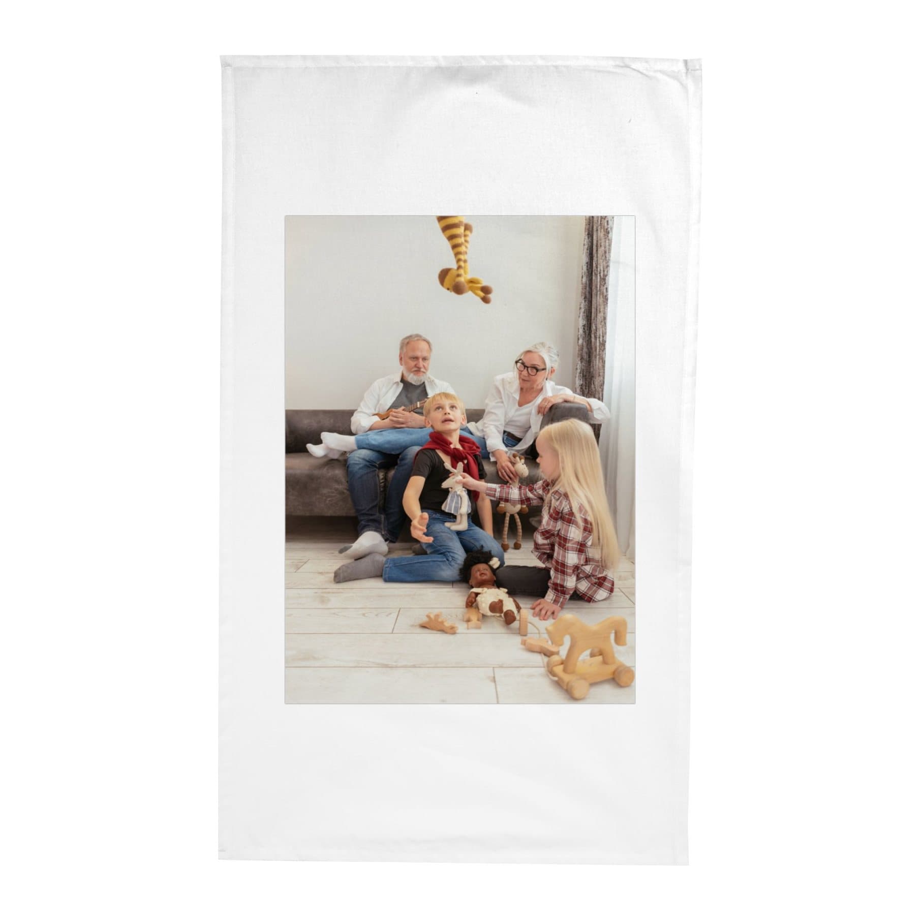 White tea towel printed with grandparents playing with their grandchildren