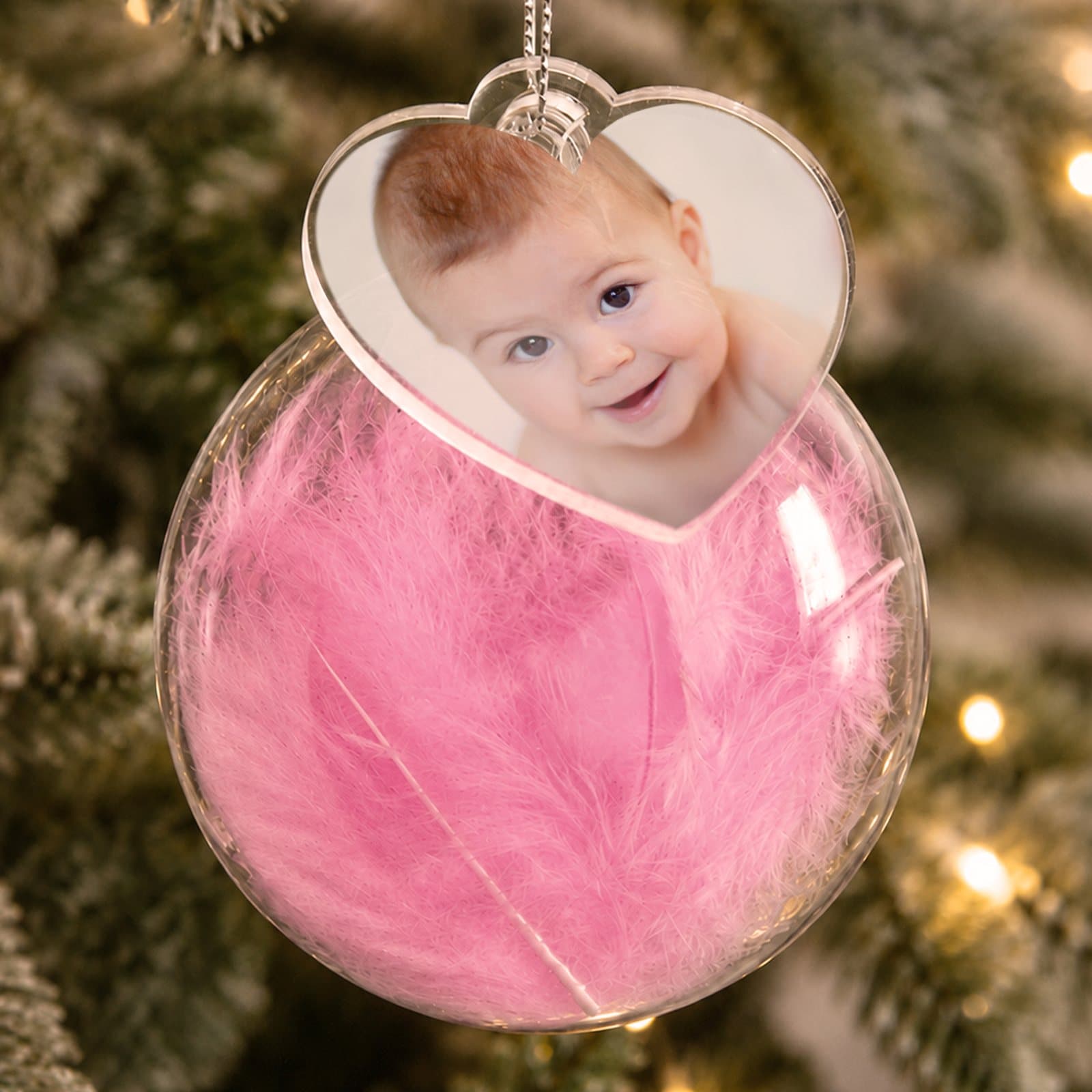 Glass bauble filled with a feather and a heart tag