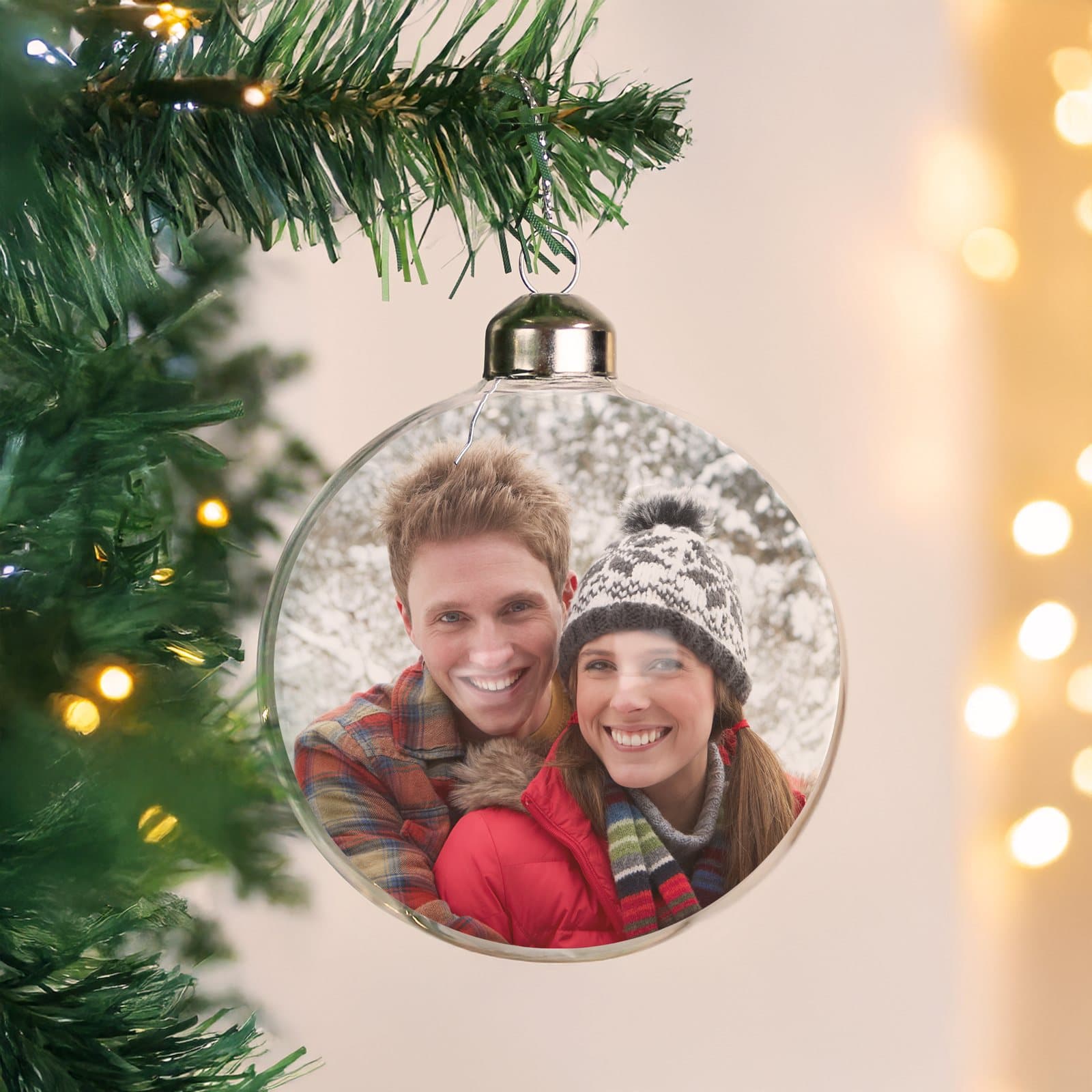 Glass Christmas bauble holding a photo, on a ribbon