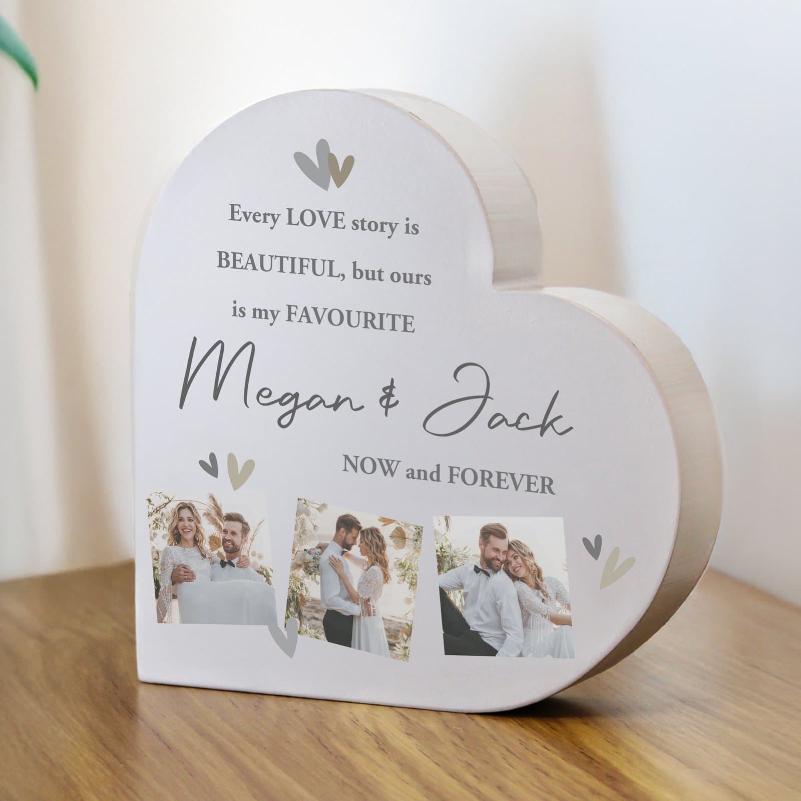 Grey wooden heart ornament with photos and lines of text