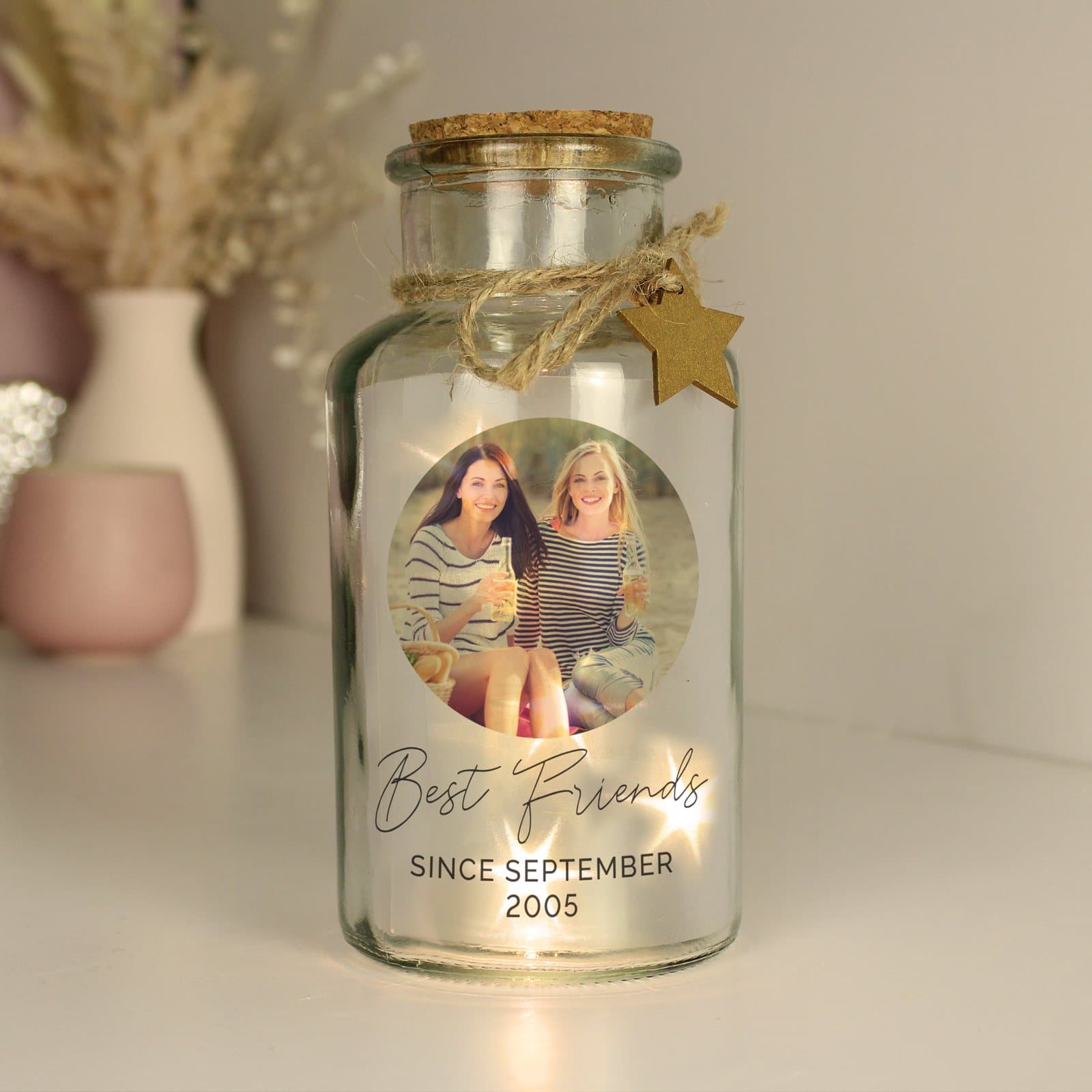 Glass jar with an LED light, a photo and a script line of text