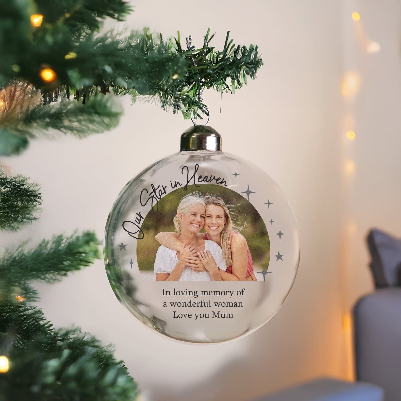 Glass memorial bauble with a photo, the words Our Star in Heaven and a ribbon