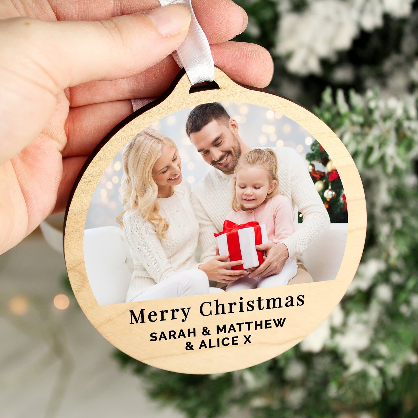 Round wooden Christmas decoration with a photo, text and ribbon