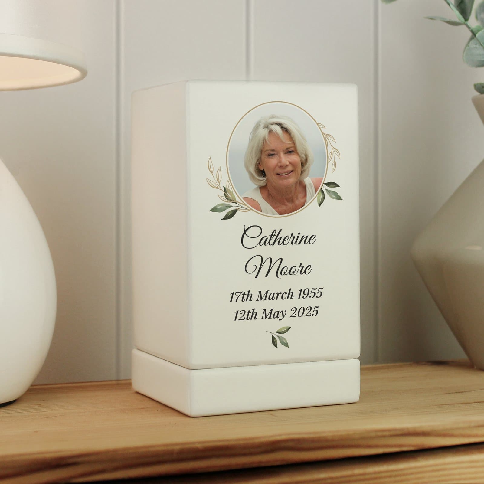 Small wooden urn with a botanical design, photo and lines of text