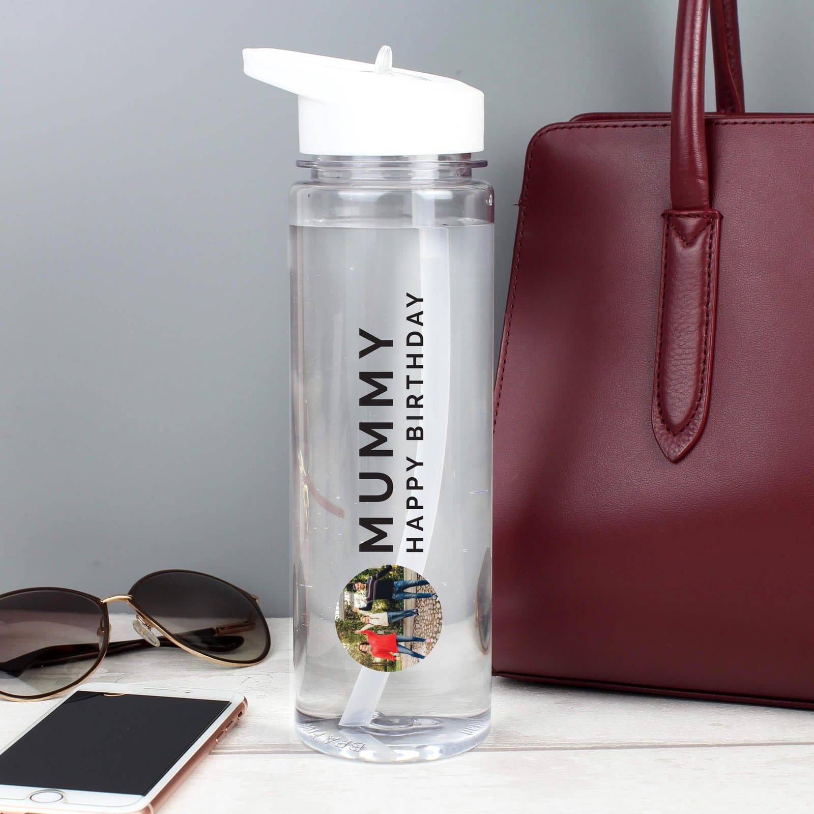 Water bottle with a white lid, a photo and two lines of text