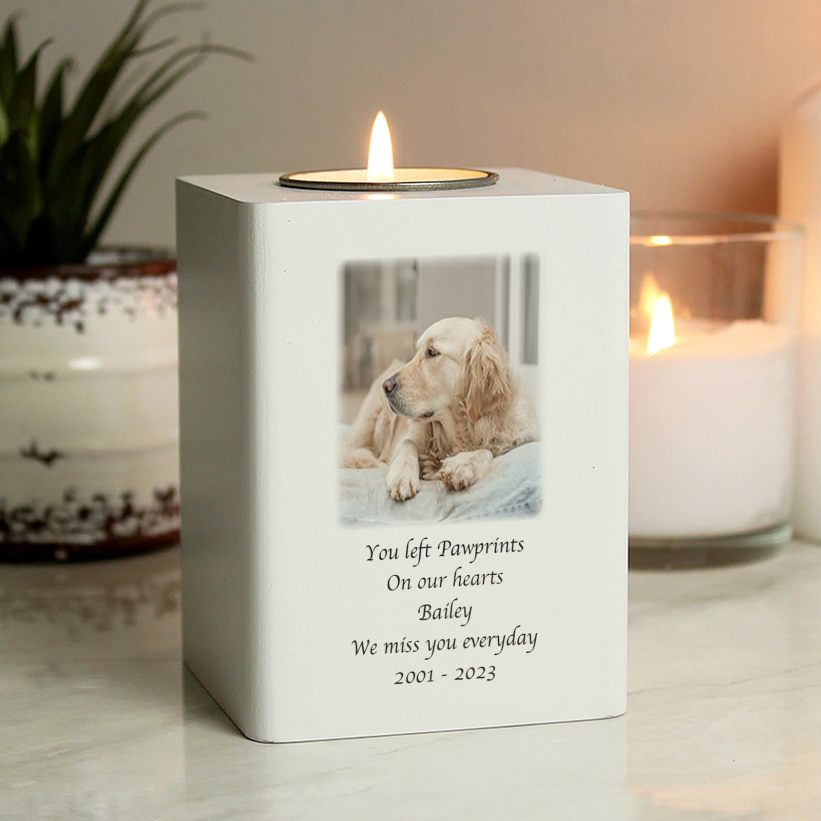 White wooden tea light holder with a photo and lines of text