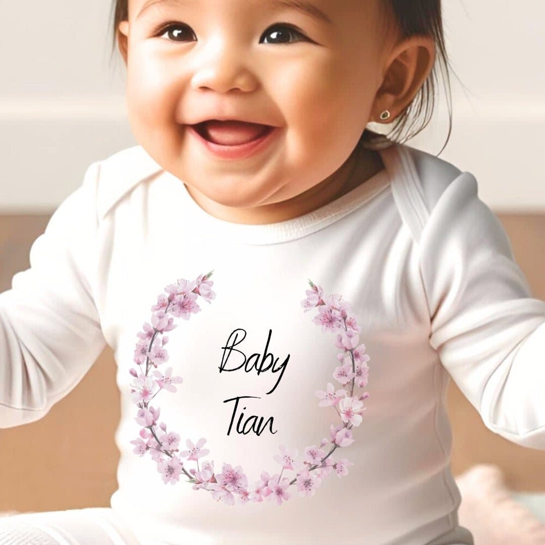 Pink blossom personalised baby grow, vest or bib with a name