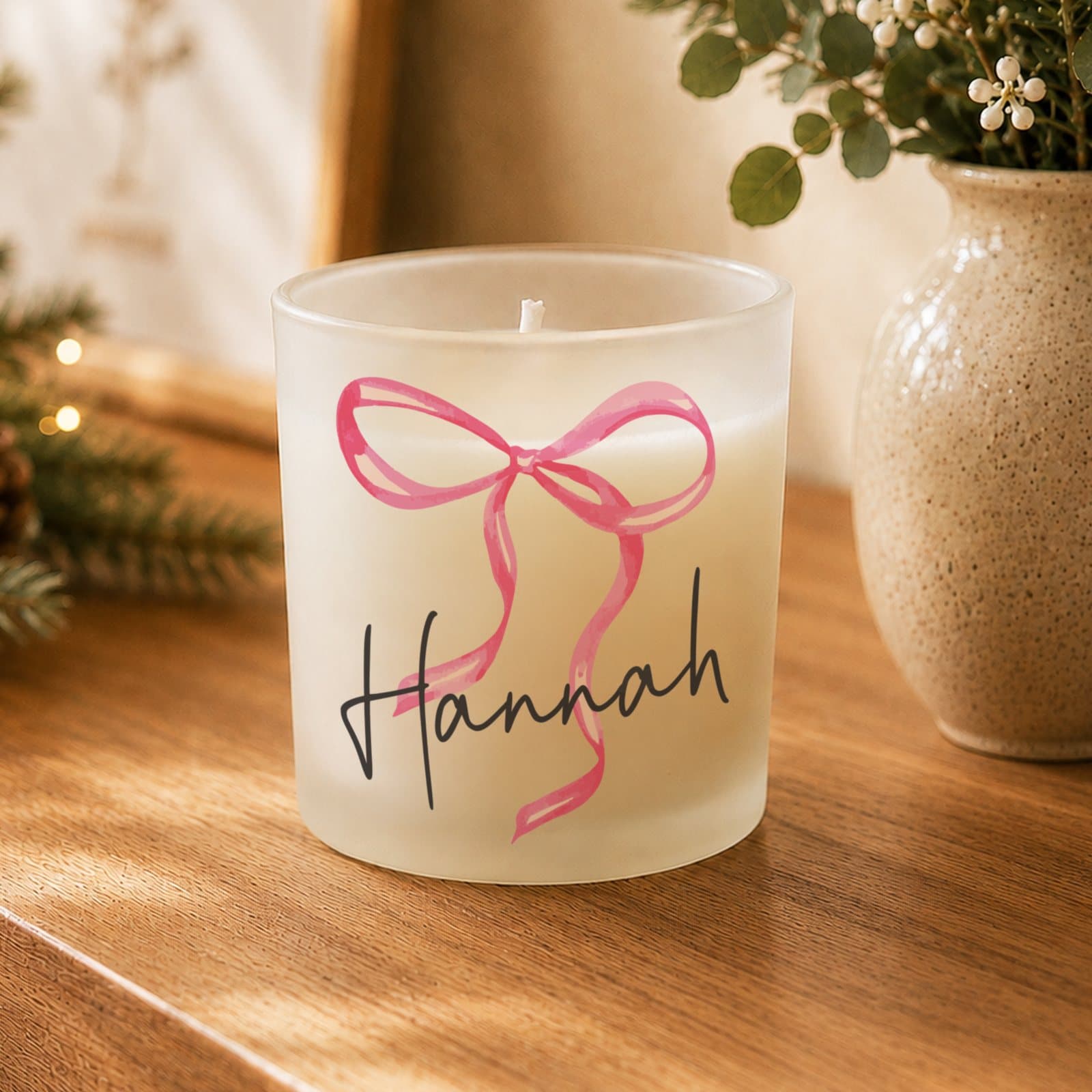 Glass candle jar with a pink bow and a personalised name