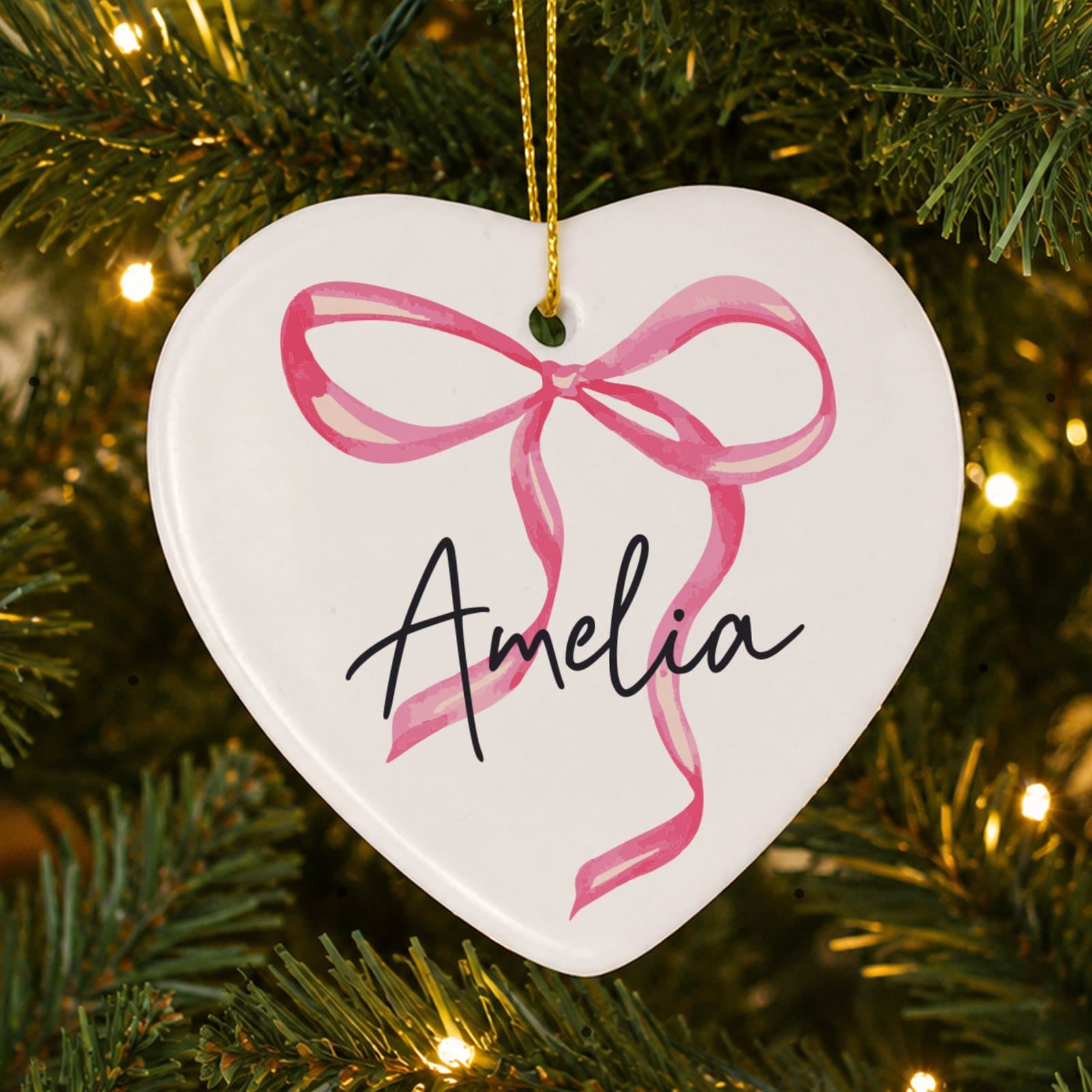 Ceramic heart decoration with a pink bow, a name and a ribbon