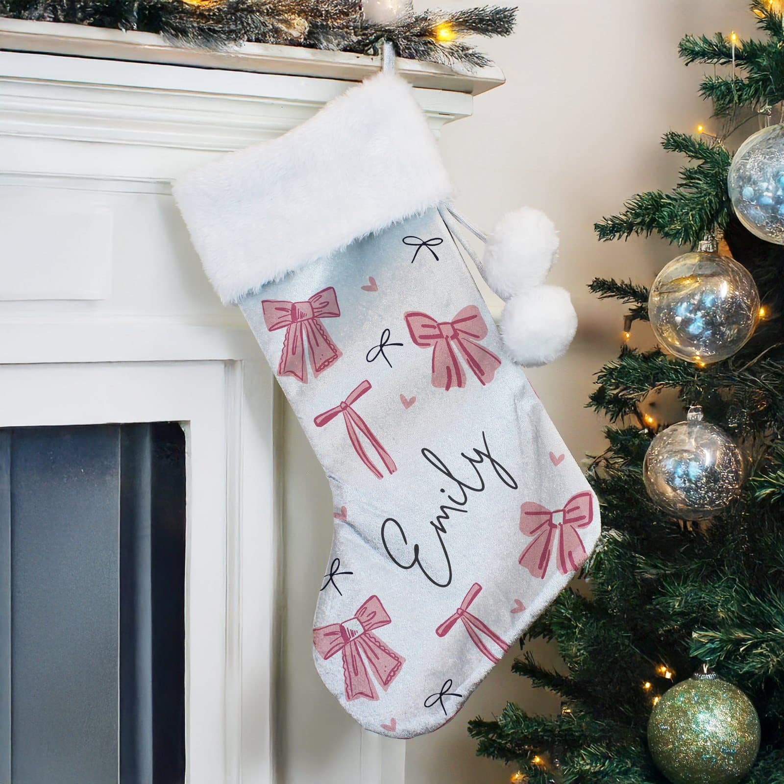 Pink velvet Christmas stocking with a bow print and a plush white cuff