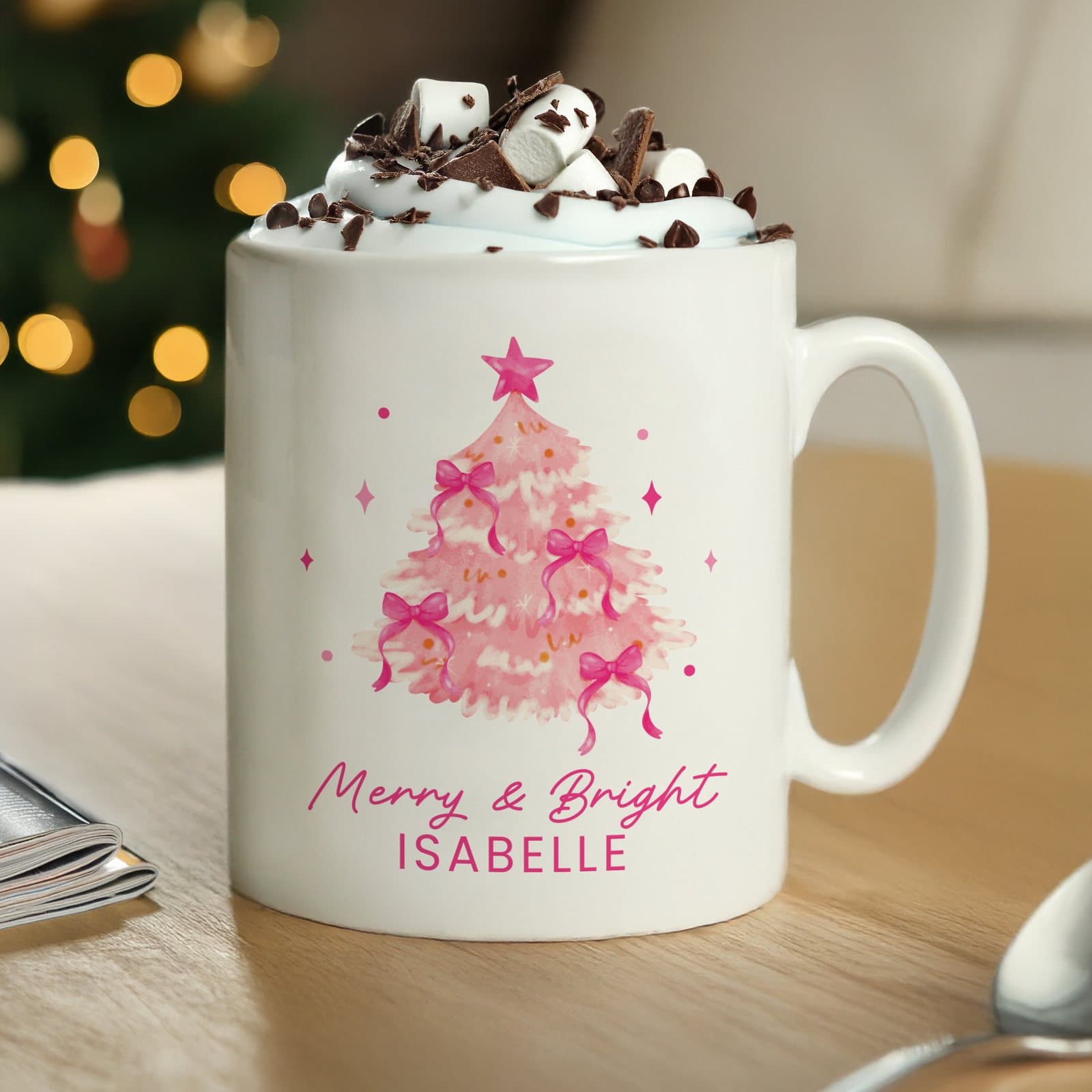 Pink ceramic mug with a Christmas tree design and personalised text