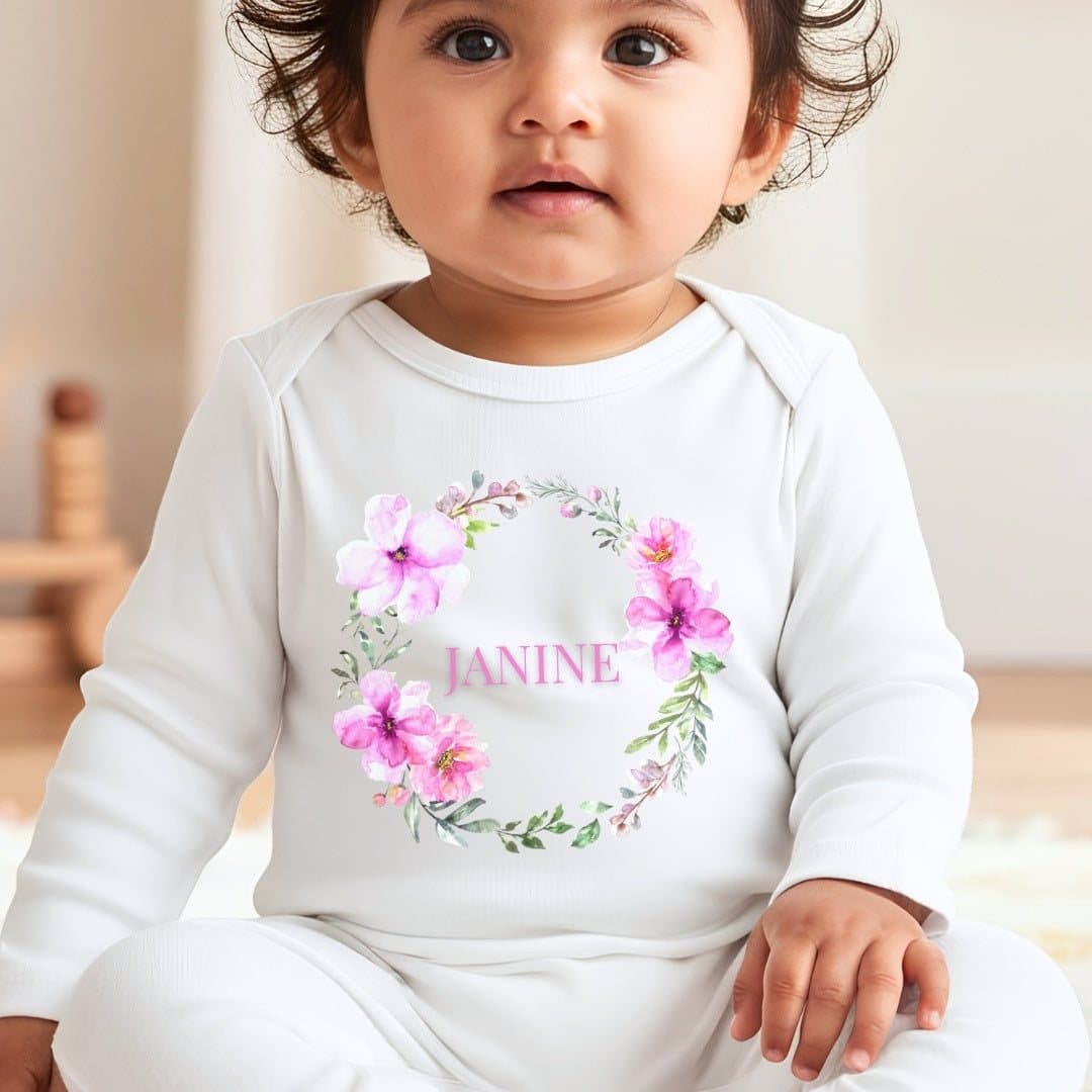 Personalised pink flower wreath baby outfit with a name added to the floral artwork