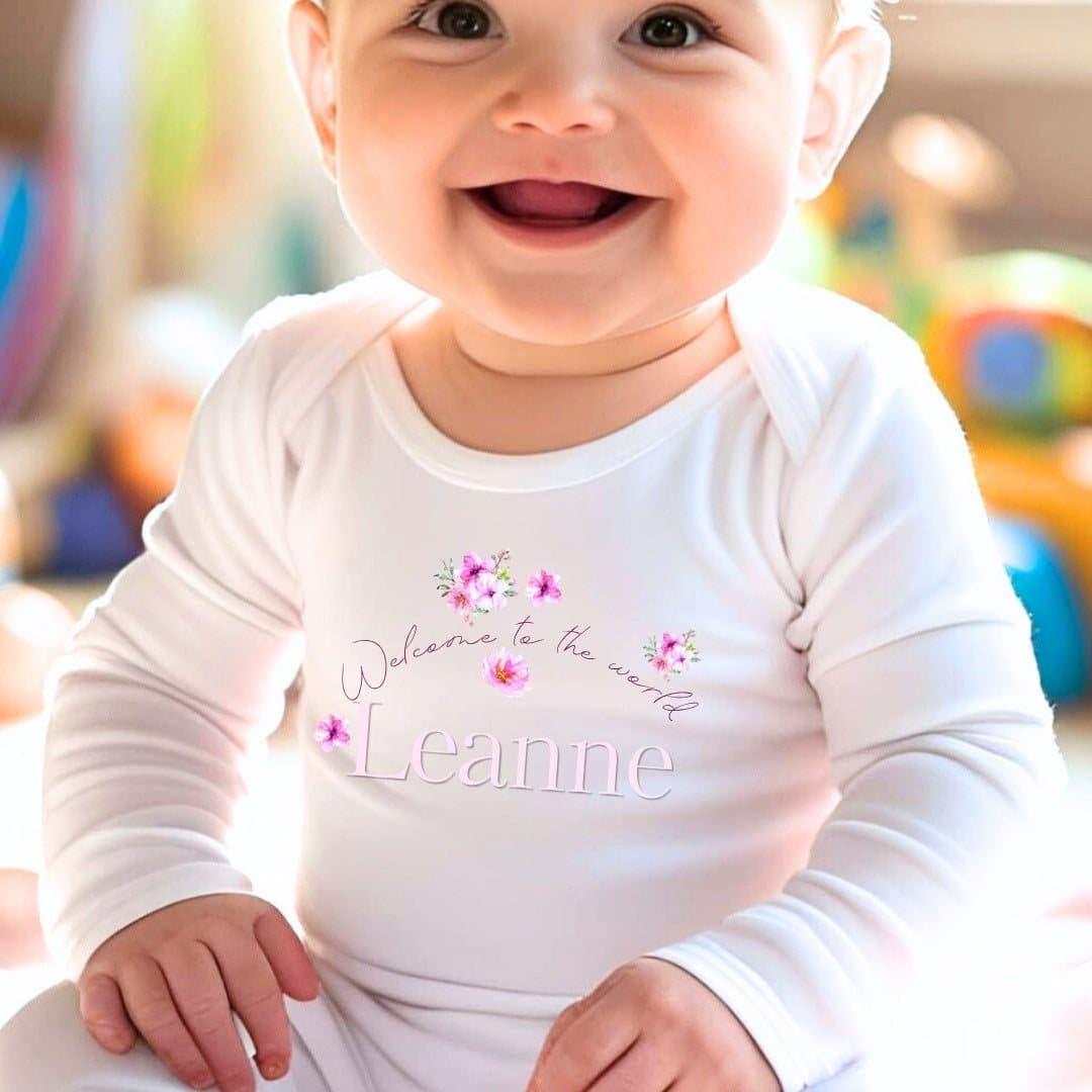 Personalised pink flowers baby outfit with pretty flower artwork and a name