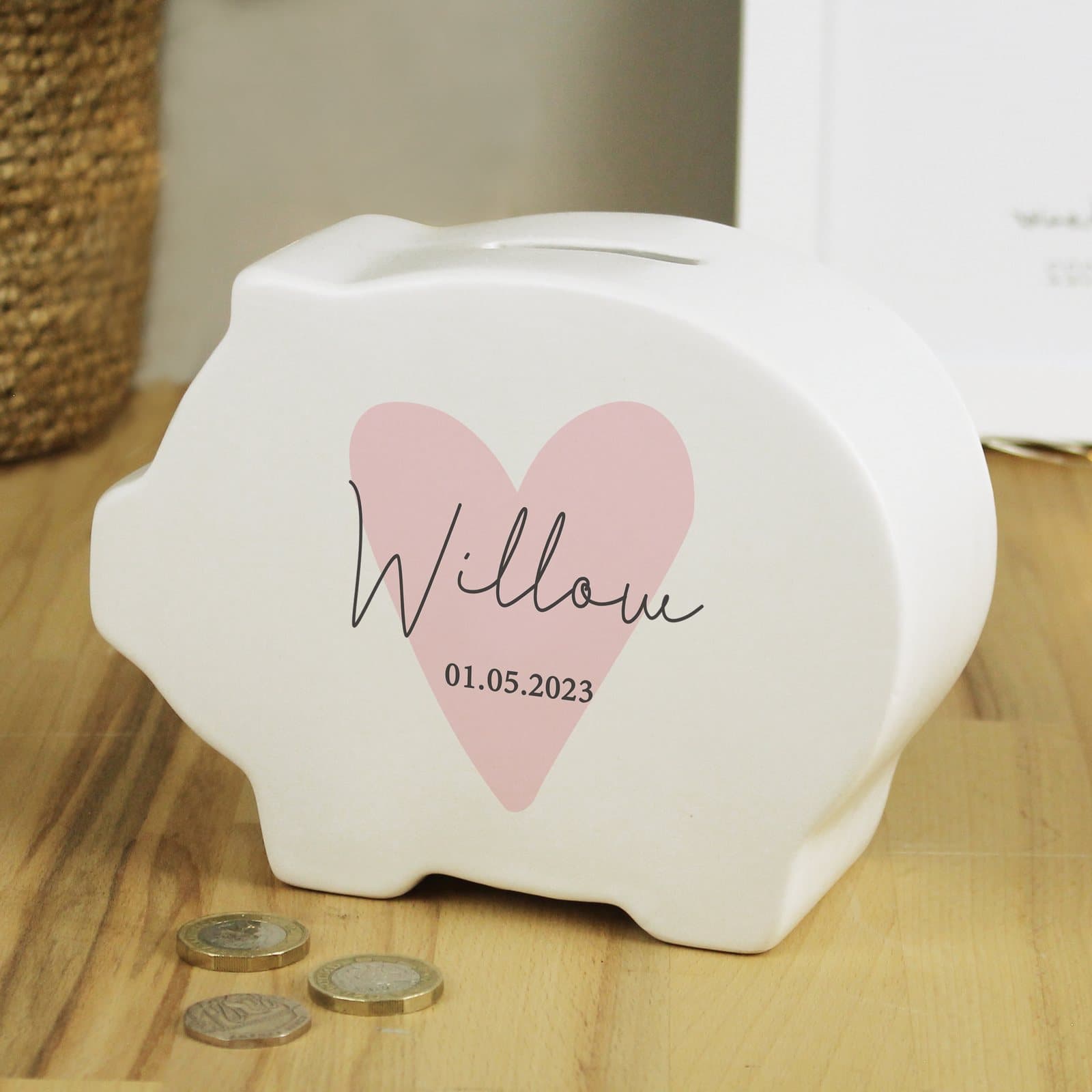 Pink ceramic heart piggy bank personalised with a name and message