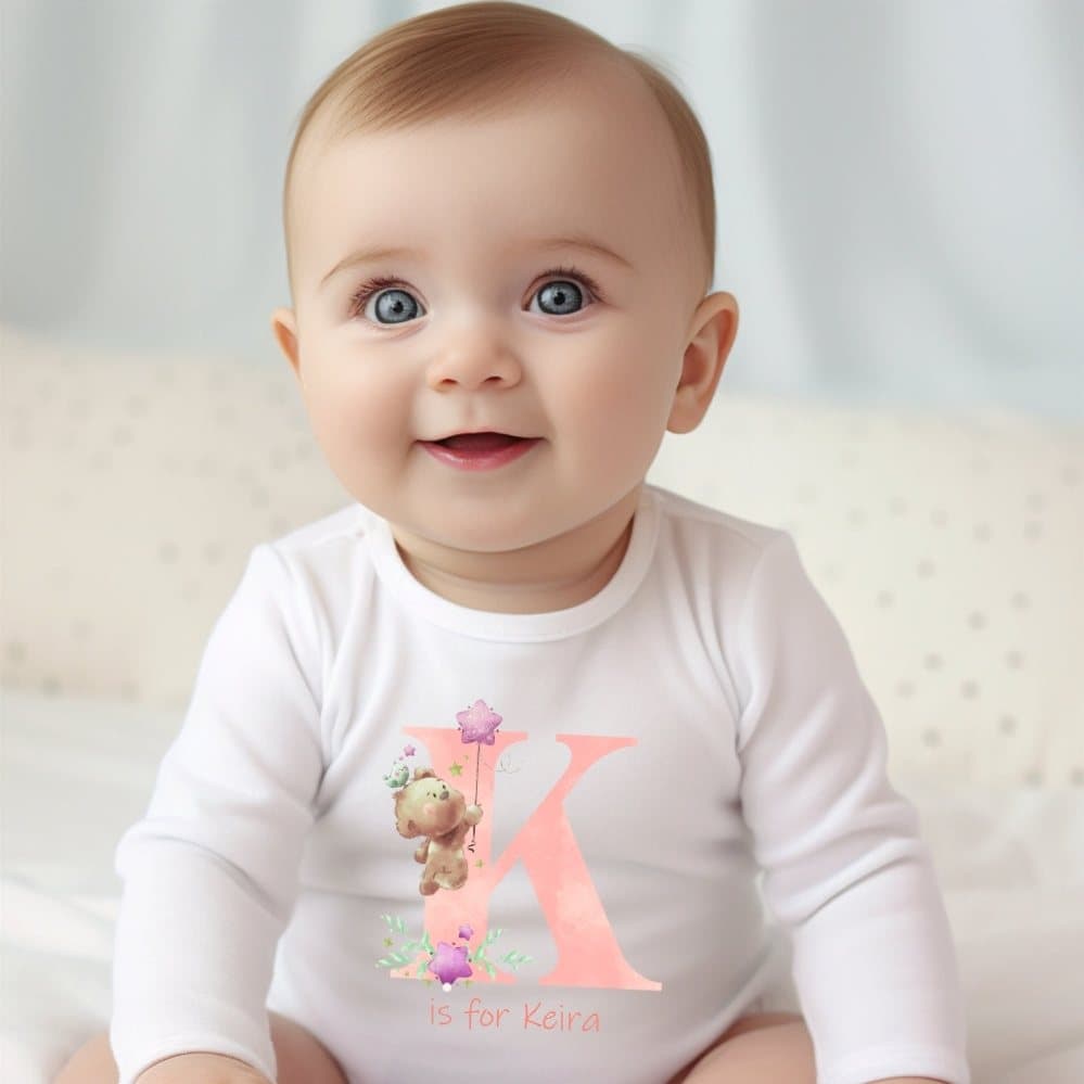 Pink personalised baby grow with an initial and teddy bear design