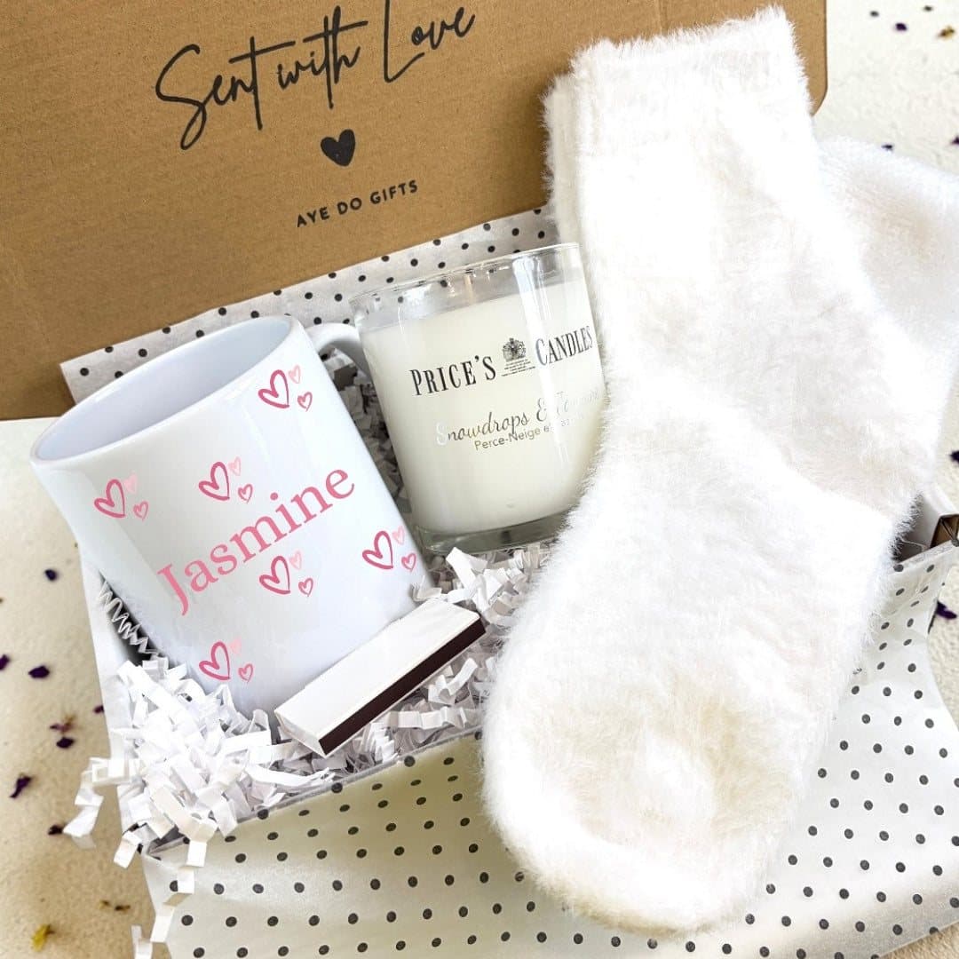 Personalised pink hearts mug with fluffy socks, a scented candle and matches
