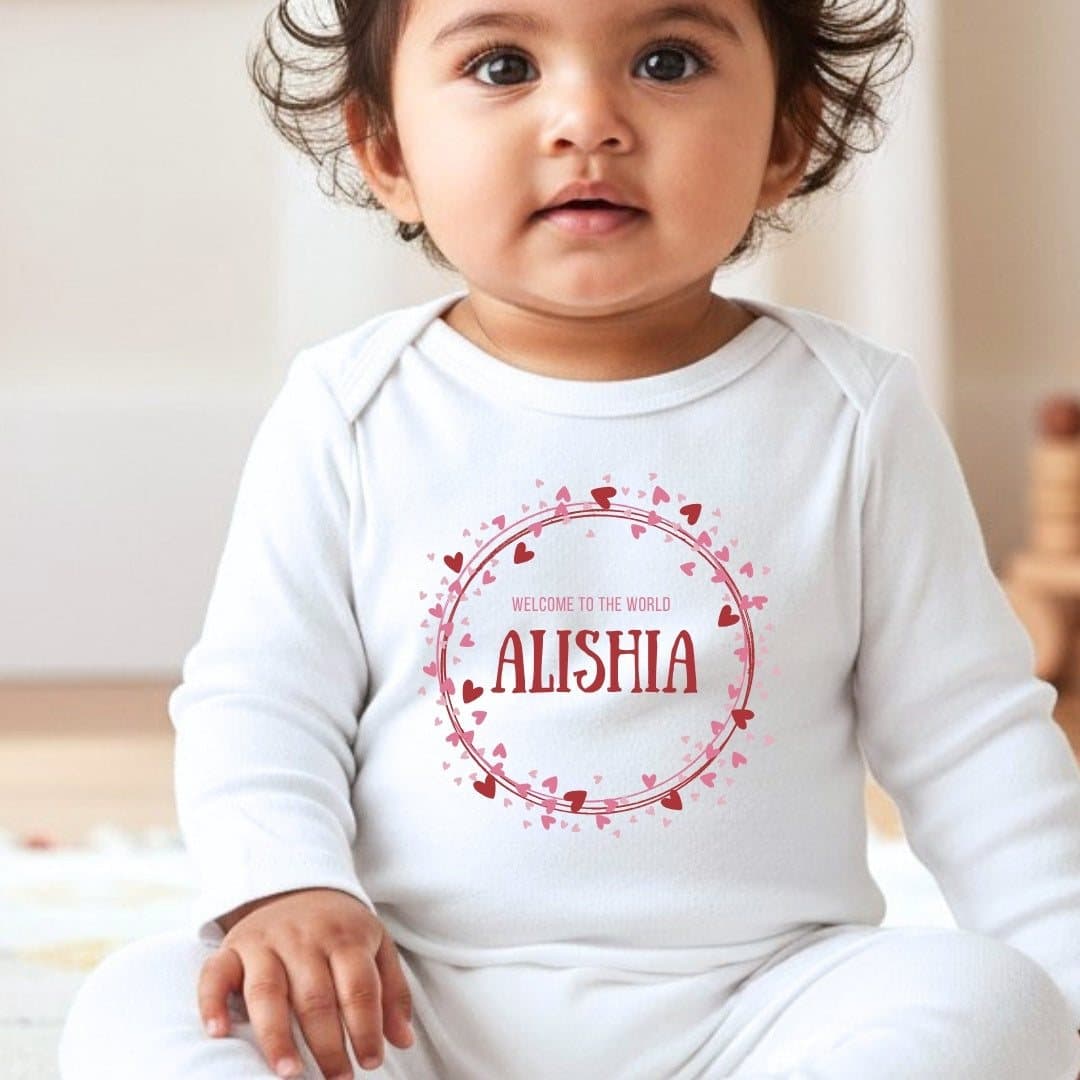 Personalised baby grow, vest or bib with pink and red hearts artwork and a name
