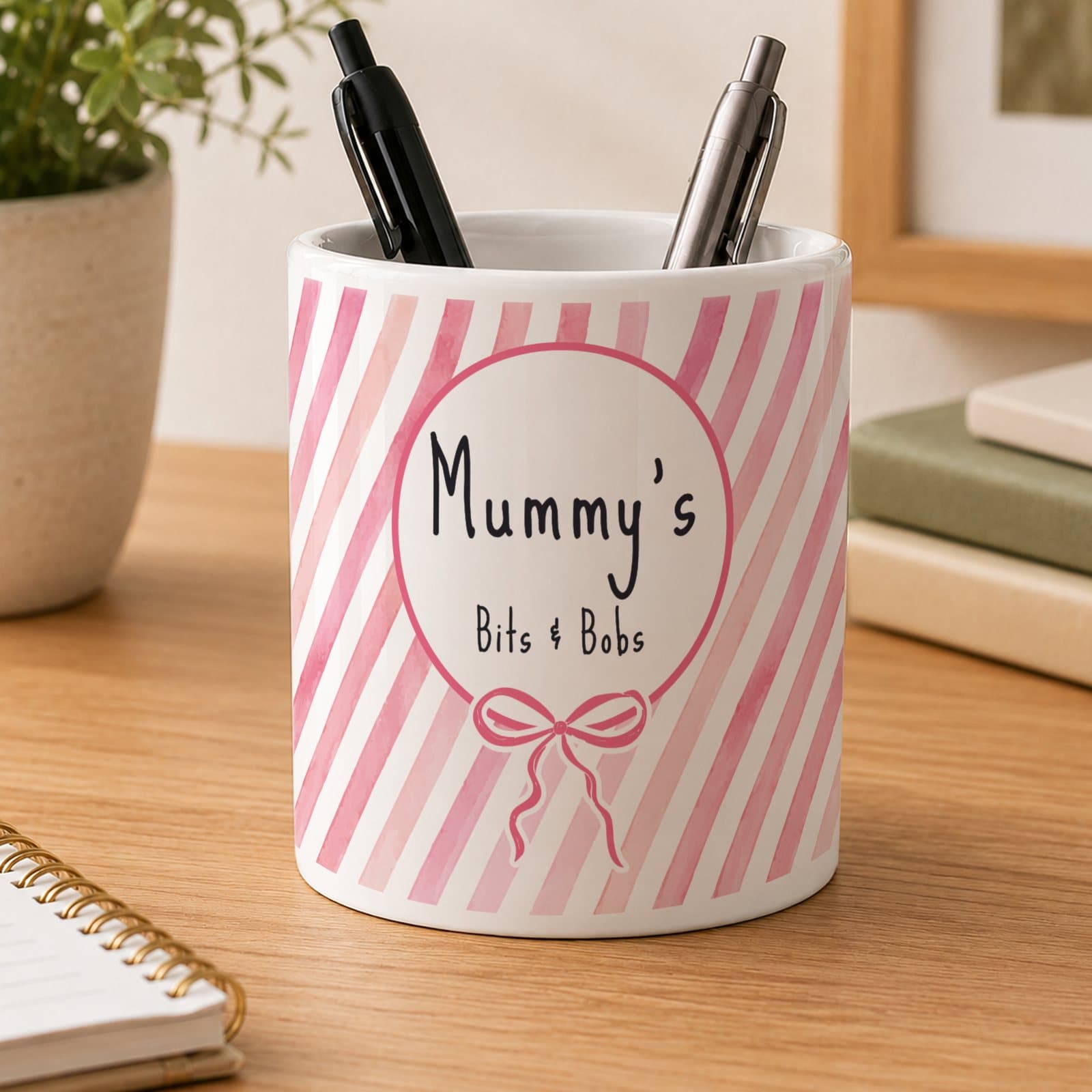 Pink striped ceramic storage pot with a bow design and two lines of personalised text