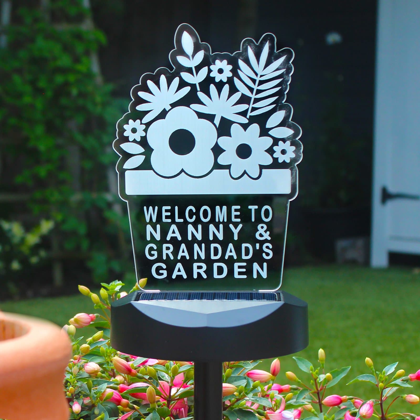 Outdoor solar light with a sign carrying four lines of personalised text