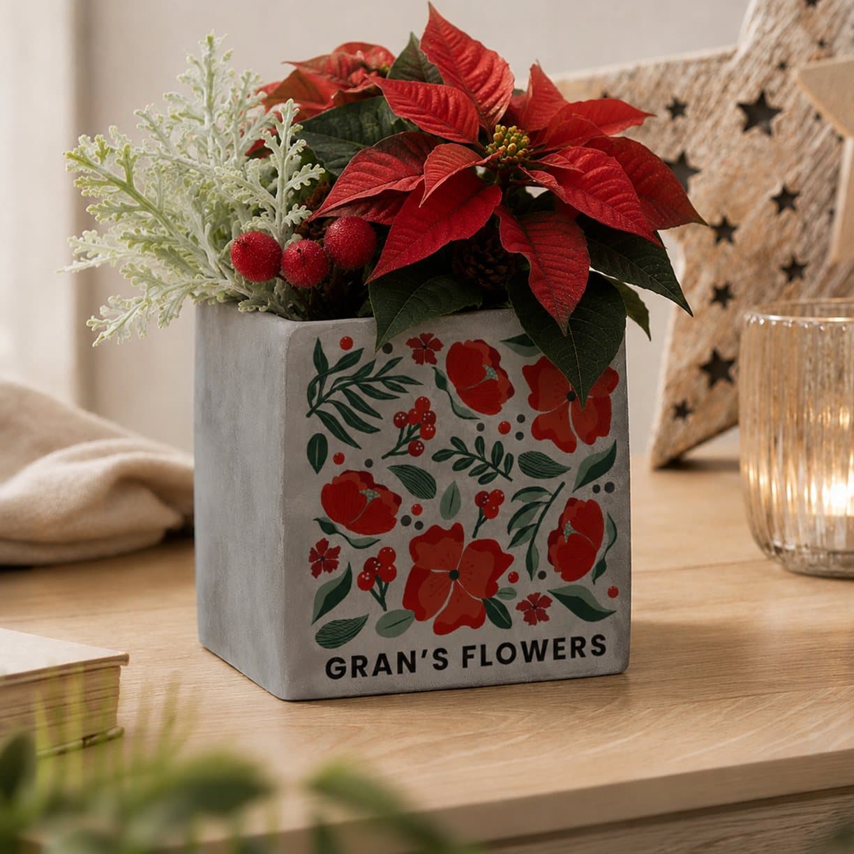Concrete plant pot with a poinsettia design and personalised text