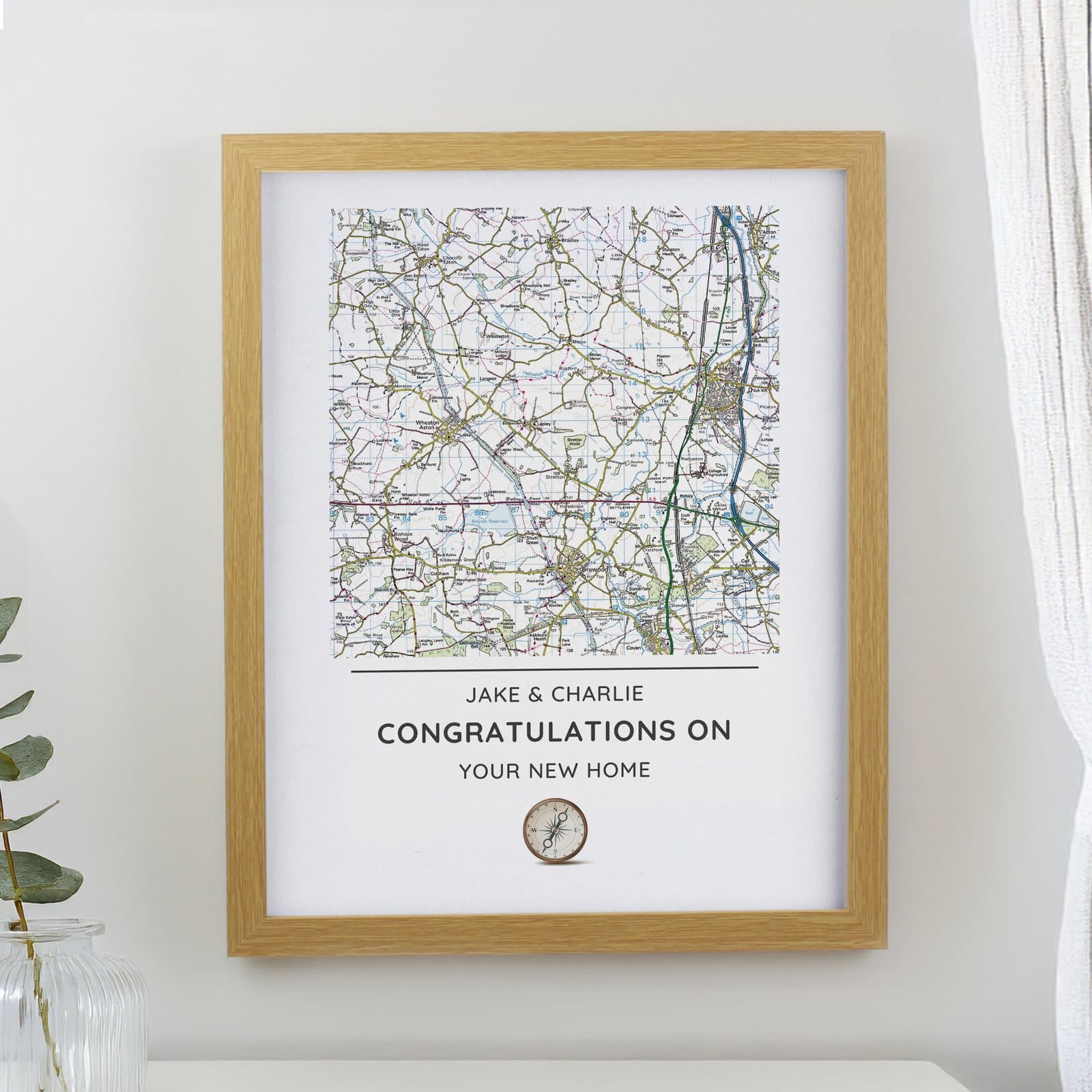 Oak framed map print of a local area with a compass design and personalised message