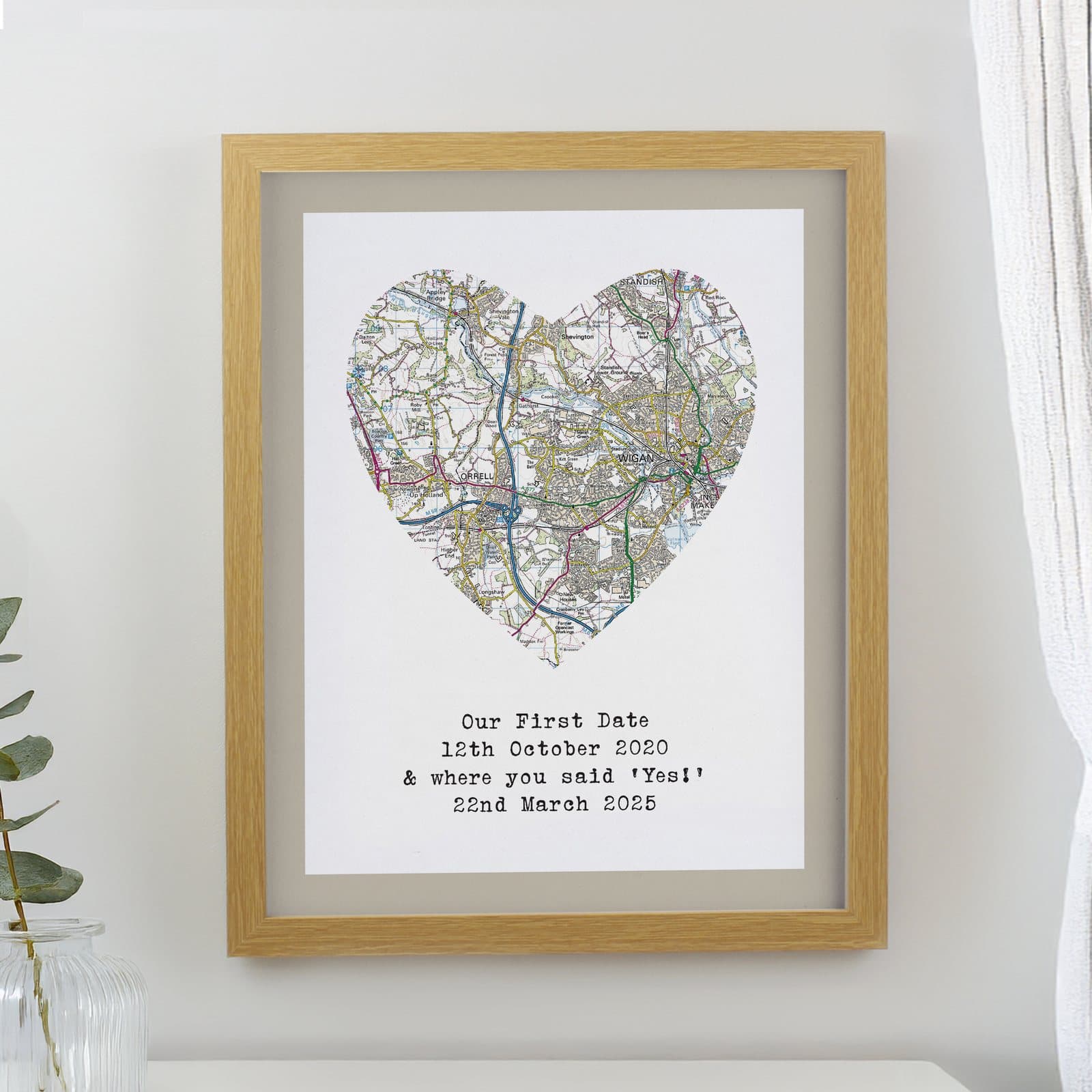 Oak framed map print of a local area with a heart design and personalised message
