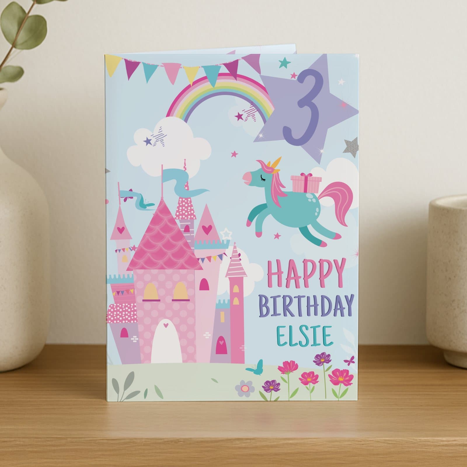 Princess birthday card showing a whimsical castle in a pastel wonderland