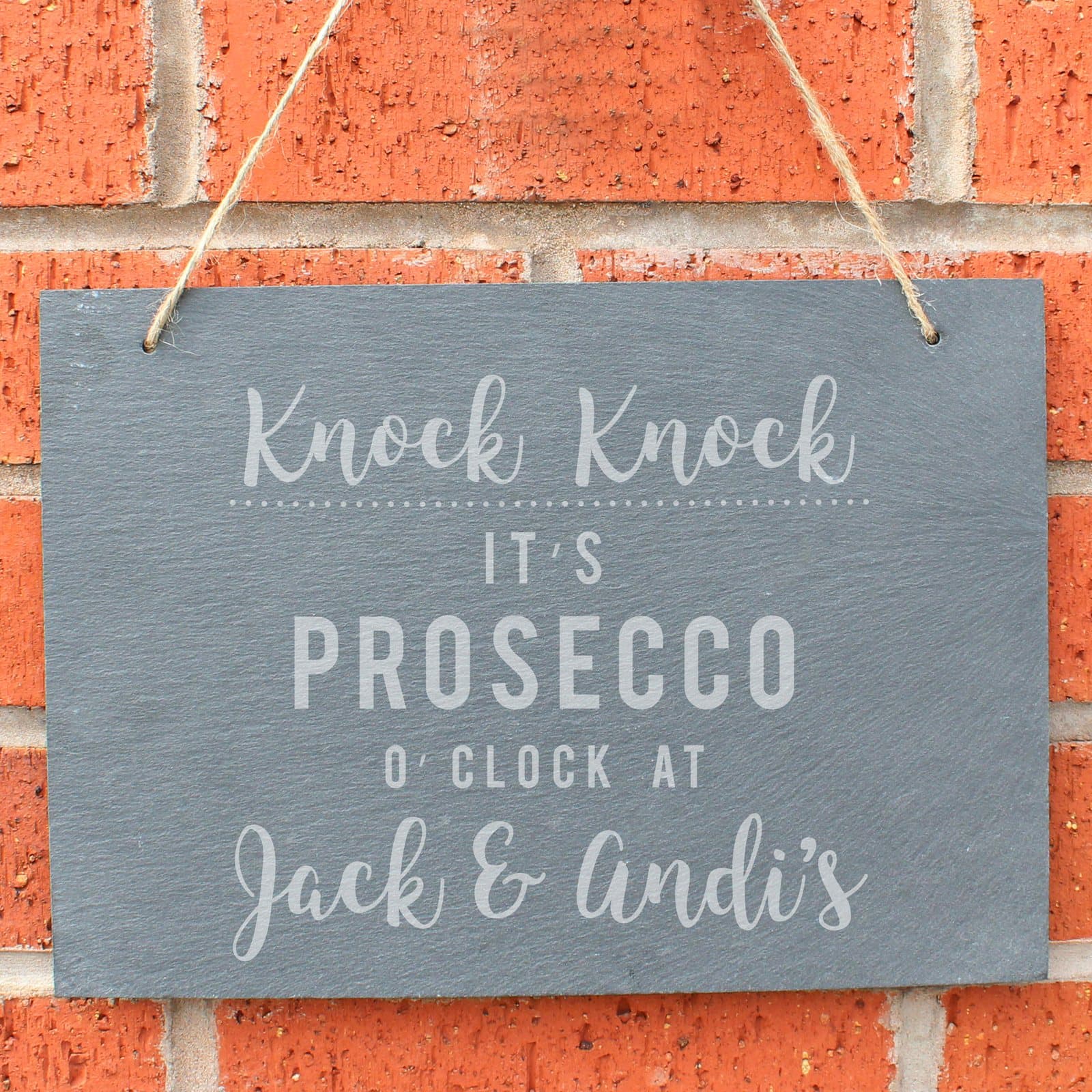 Large hanging slate sign reading Knock Knock It's Prosecco o'clock at, with a name