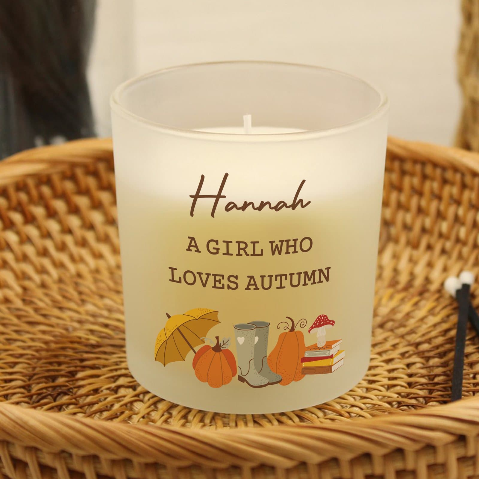 Frosted glass candle jar with a pumpkin design and personalised label