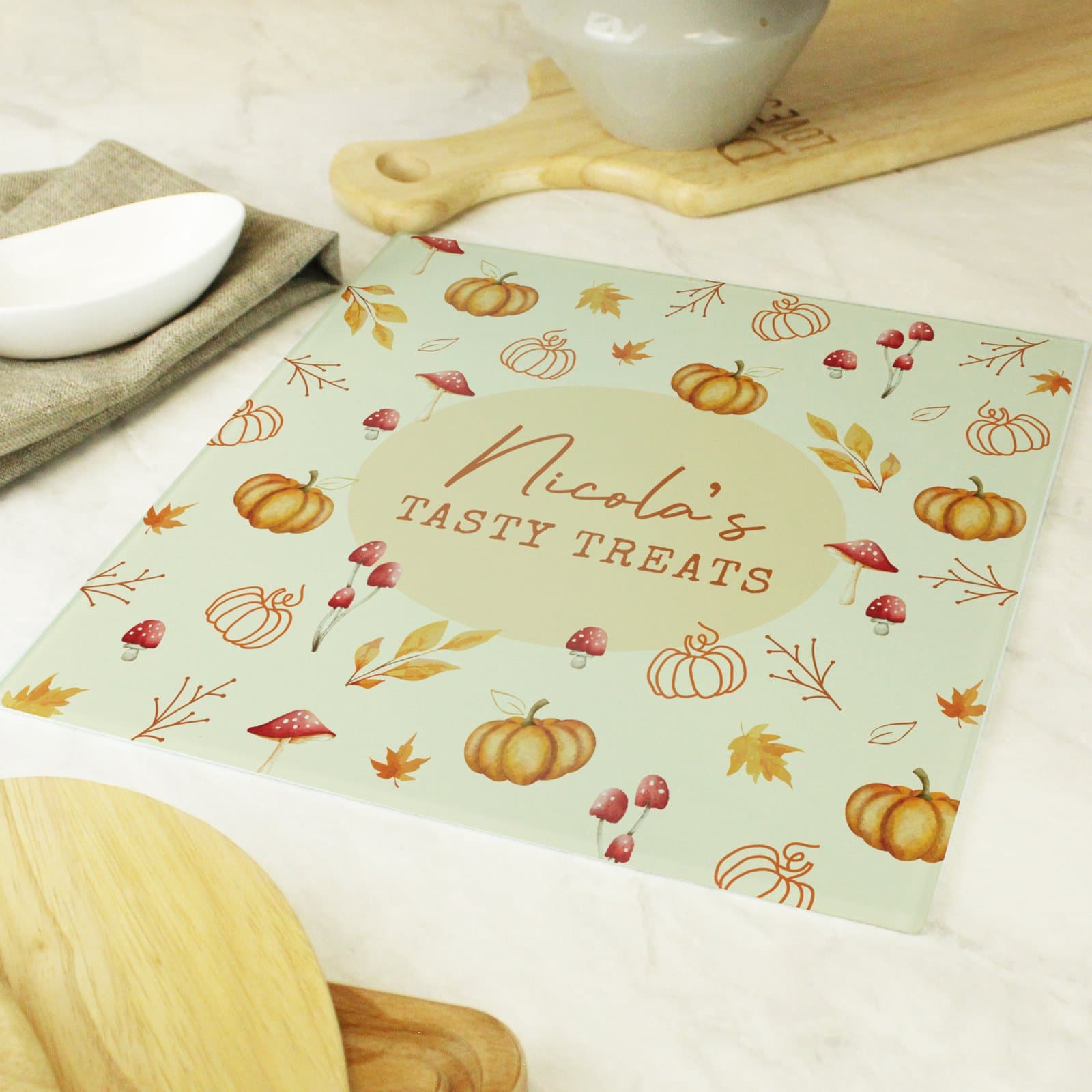 Glass chopping board with a pumpkin pattern and two lines of personalised text