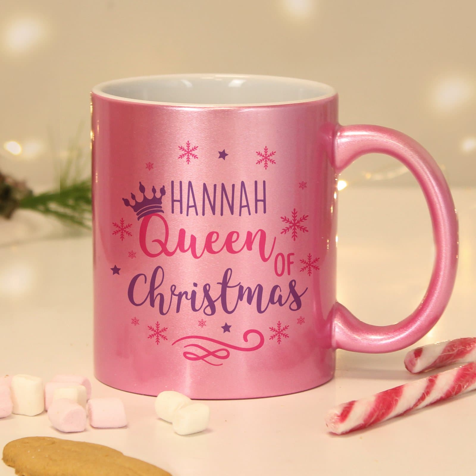 Pink ceramic Queen of Christmas mug with snowflakes and a crown