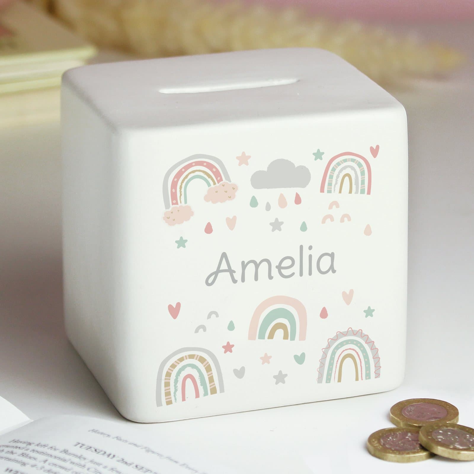 Square ceramic money box with a rainbow design and a personalised name