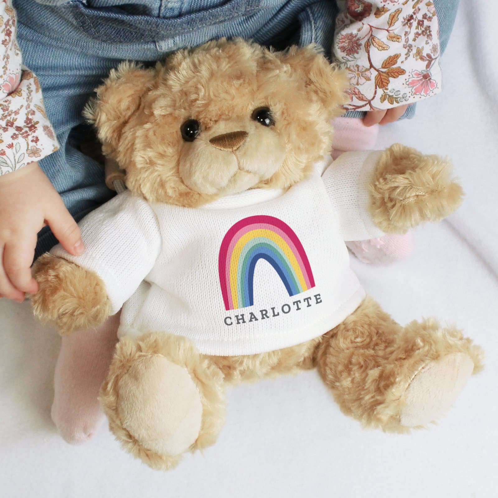 Plush rainbow teddy bear wearing a t-shirt
