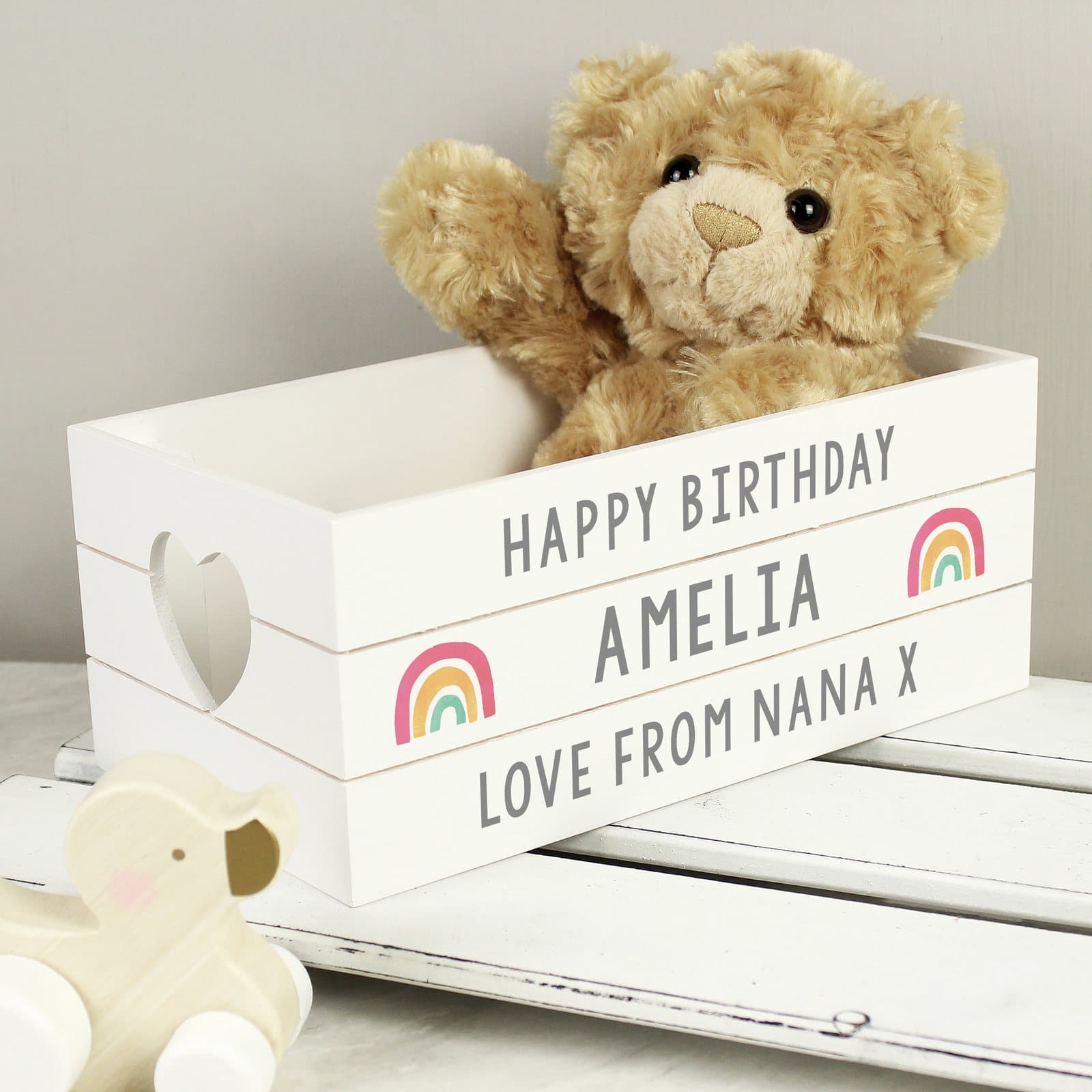 White wooden crate with heart shaped handles and rainbow design