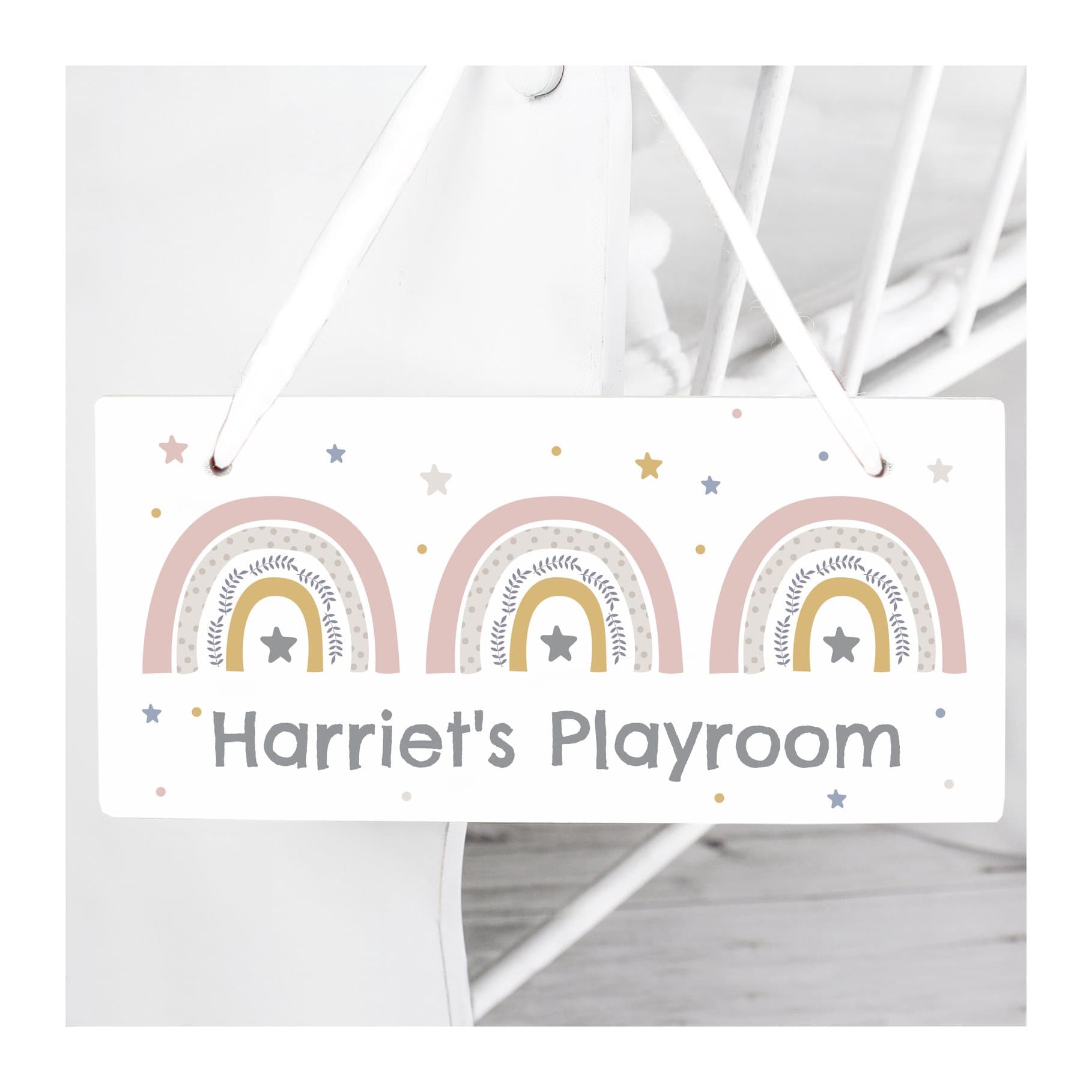 Wooden rainbow sign with a line of personalised text and ribbon