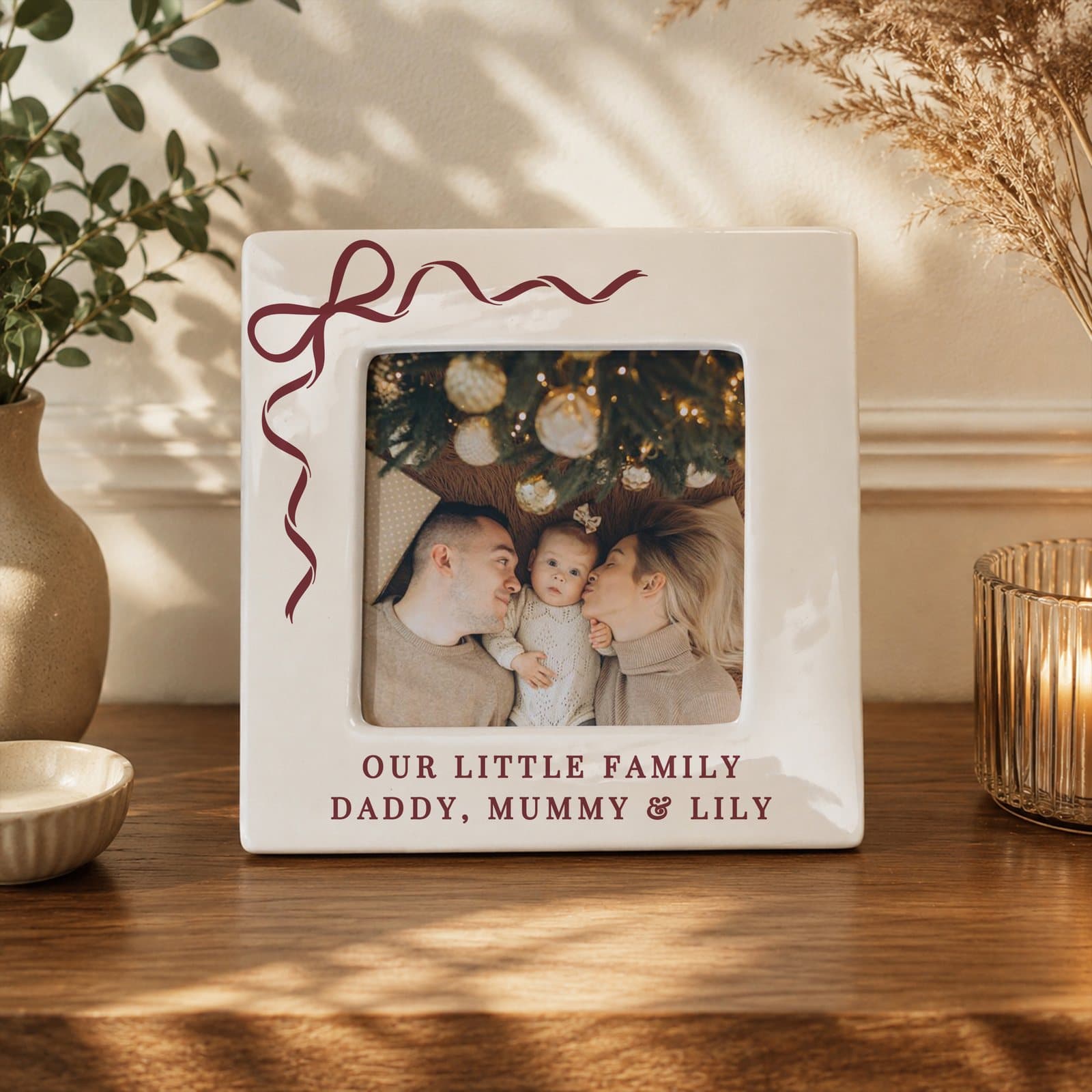 Ceramic photo frame with a red bow design and two lines of personalised text
