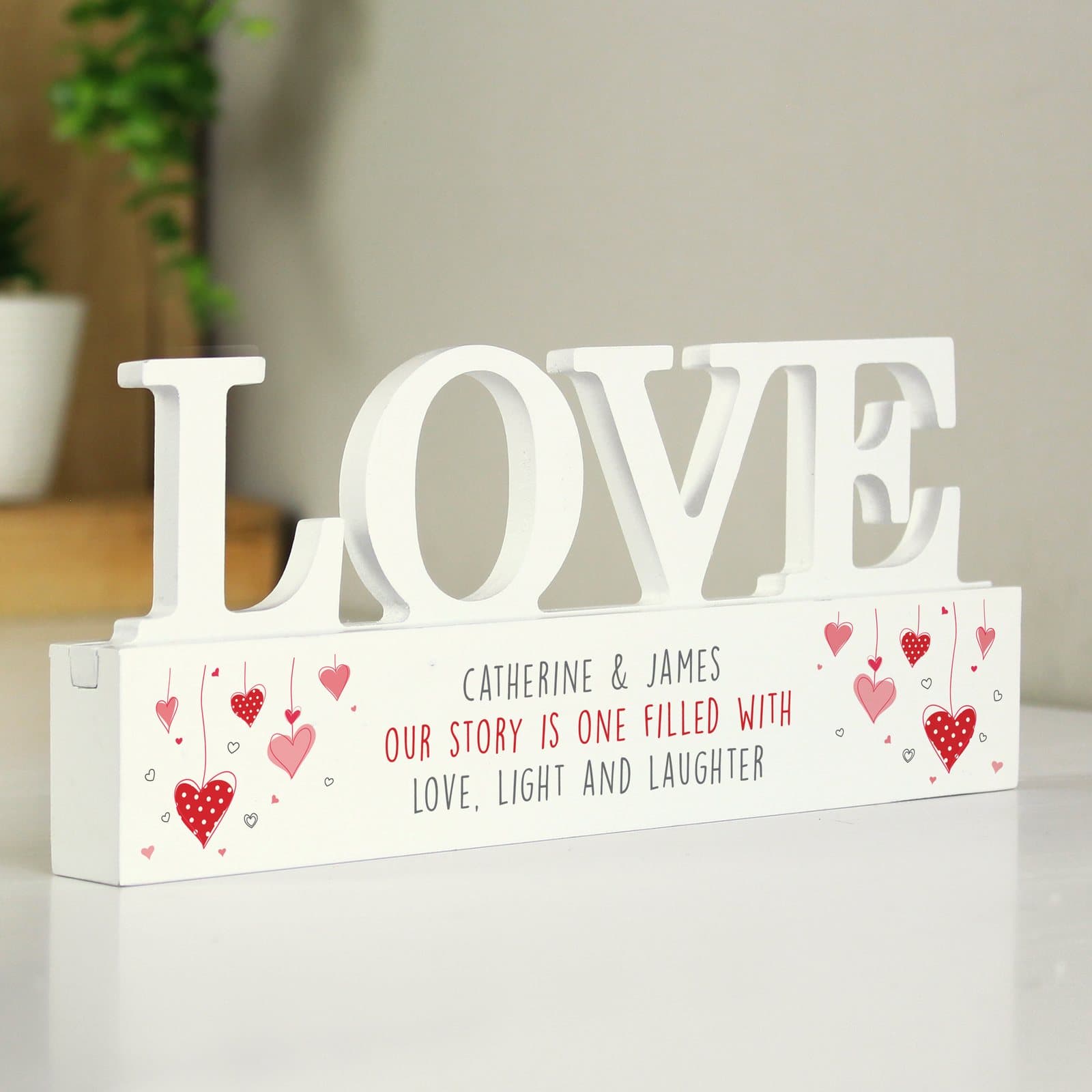 Wooden love ornament with red hearts and three lines of personalised text