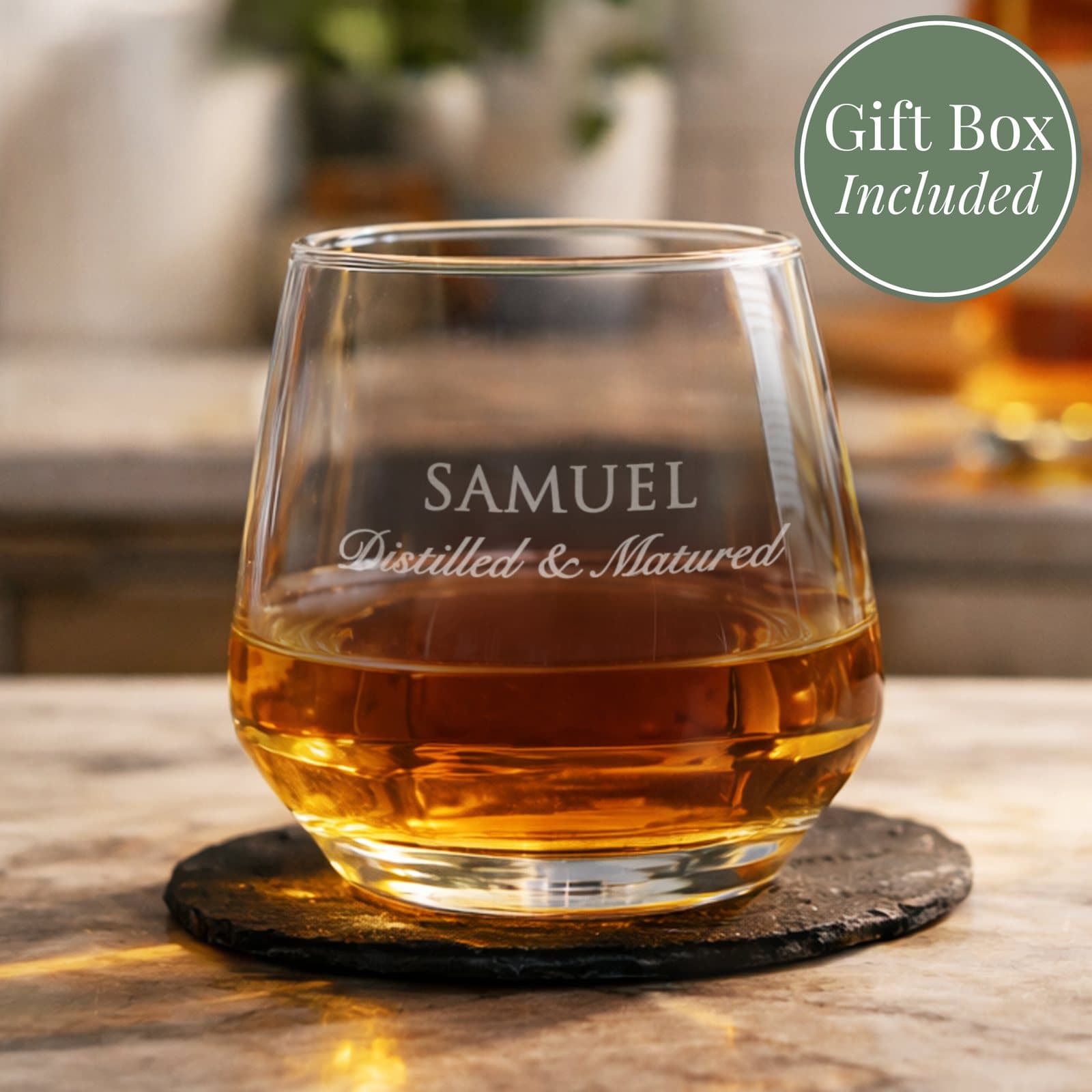 Glass tumbler engraved with two lines of personalised text beside a silver gift box
