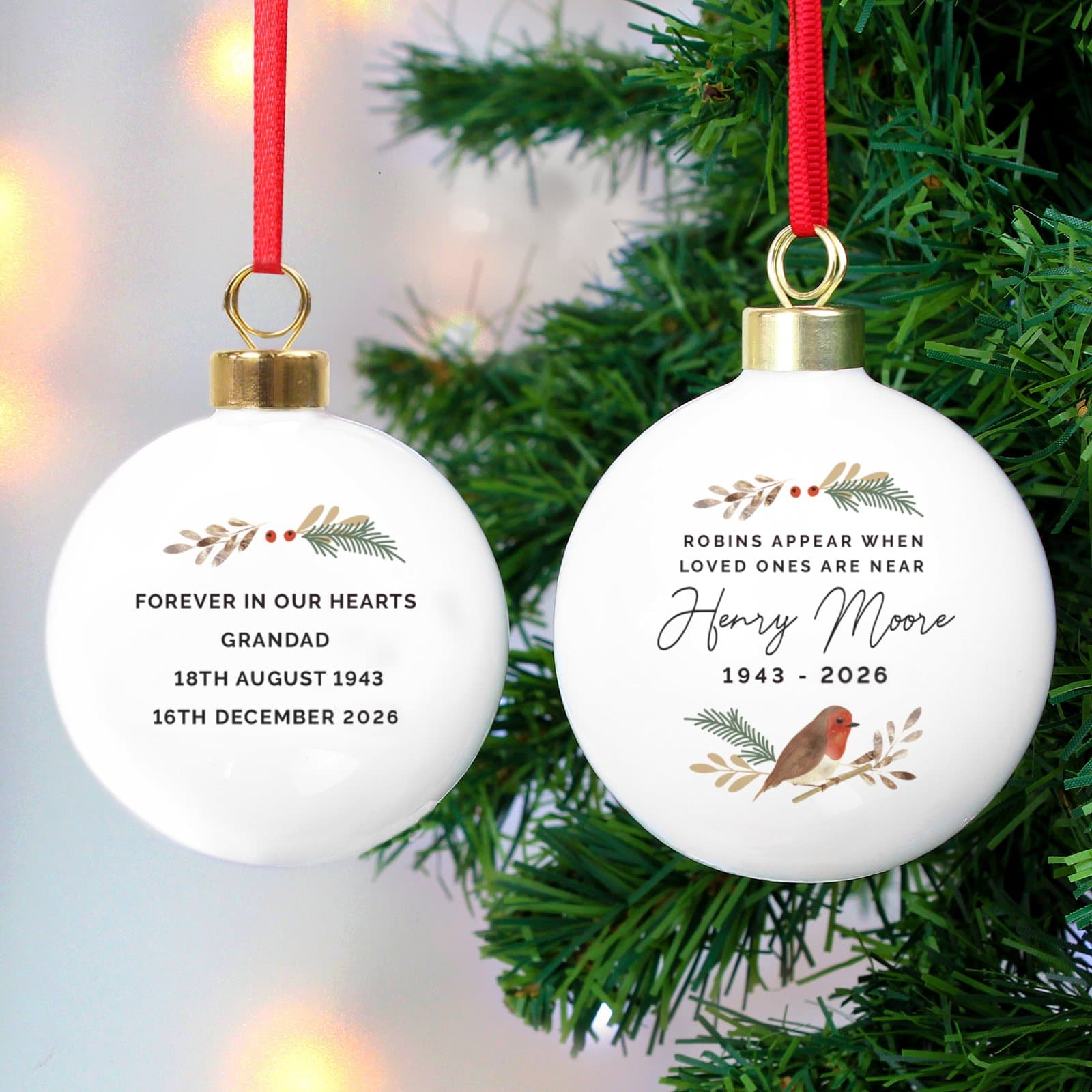 Personalised robin memorial bauble with a ribbon
