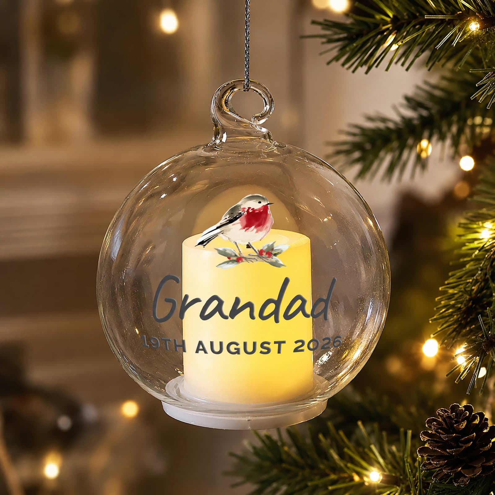 Personalised robin memorial glass bauble with a flickering LED candle inside