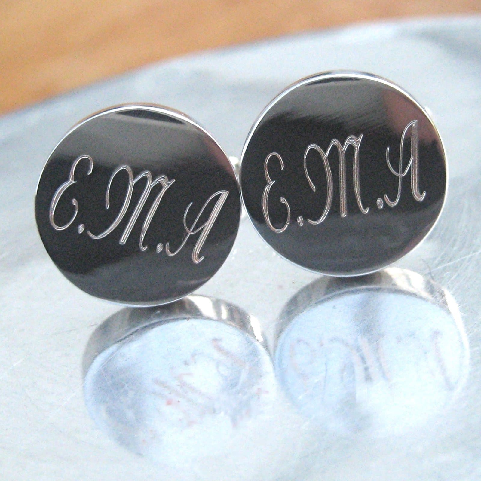 Round silver coloured cufflinks with script engraving