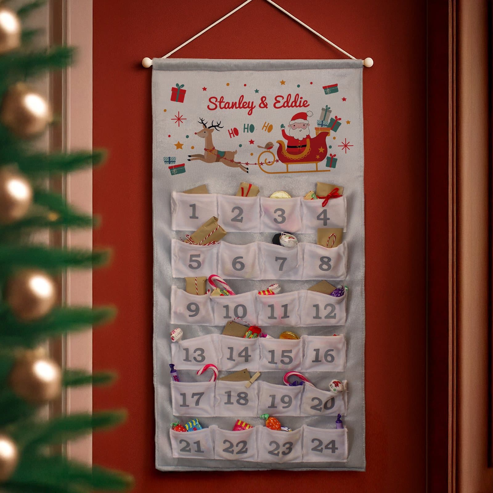 Santa sleigh advent calendar with numbered pockets and a personalised message