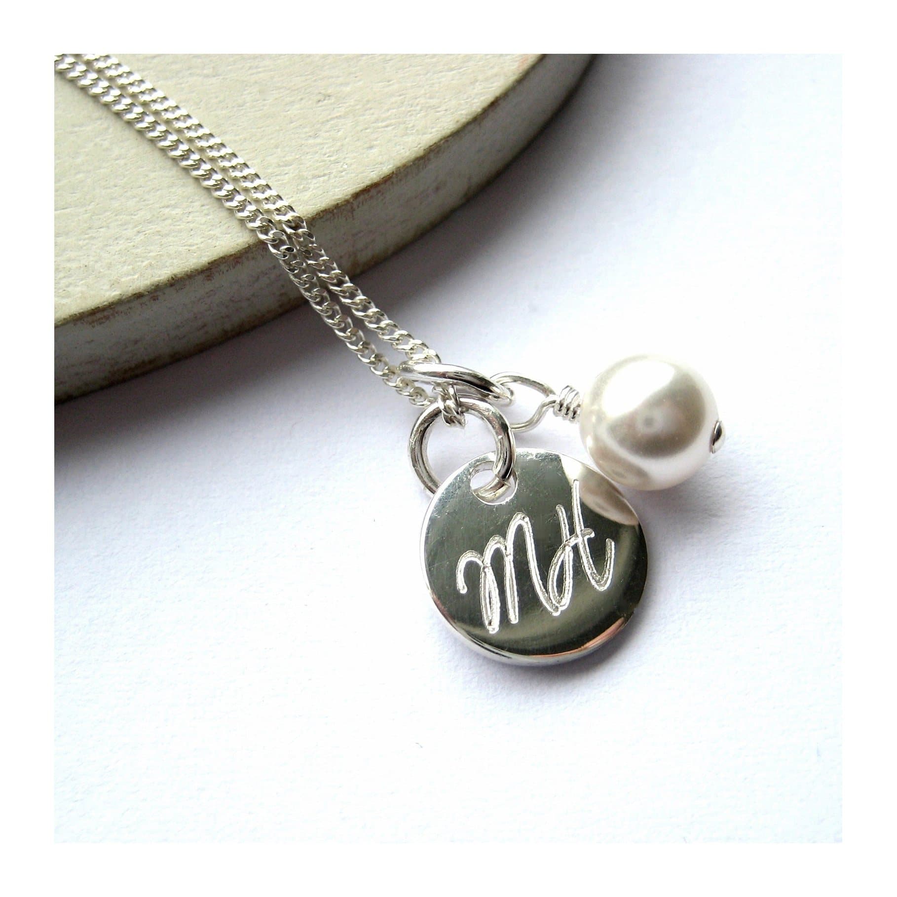 Personalised script disc necklace with a glass pearl on a sterling silver chain.