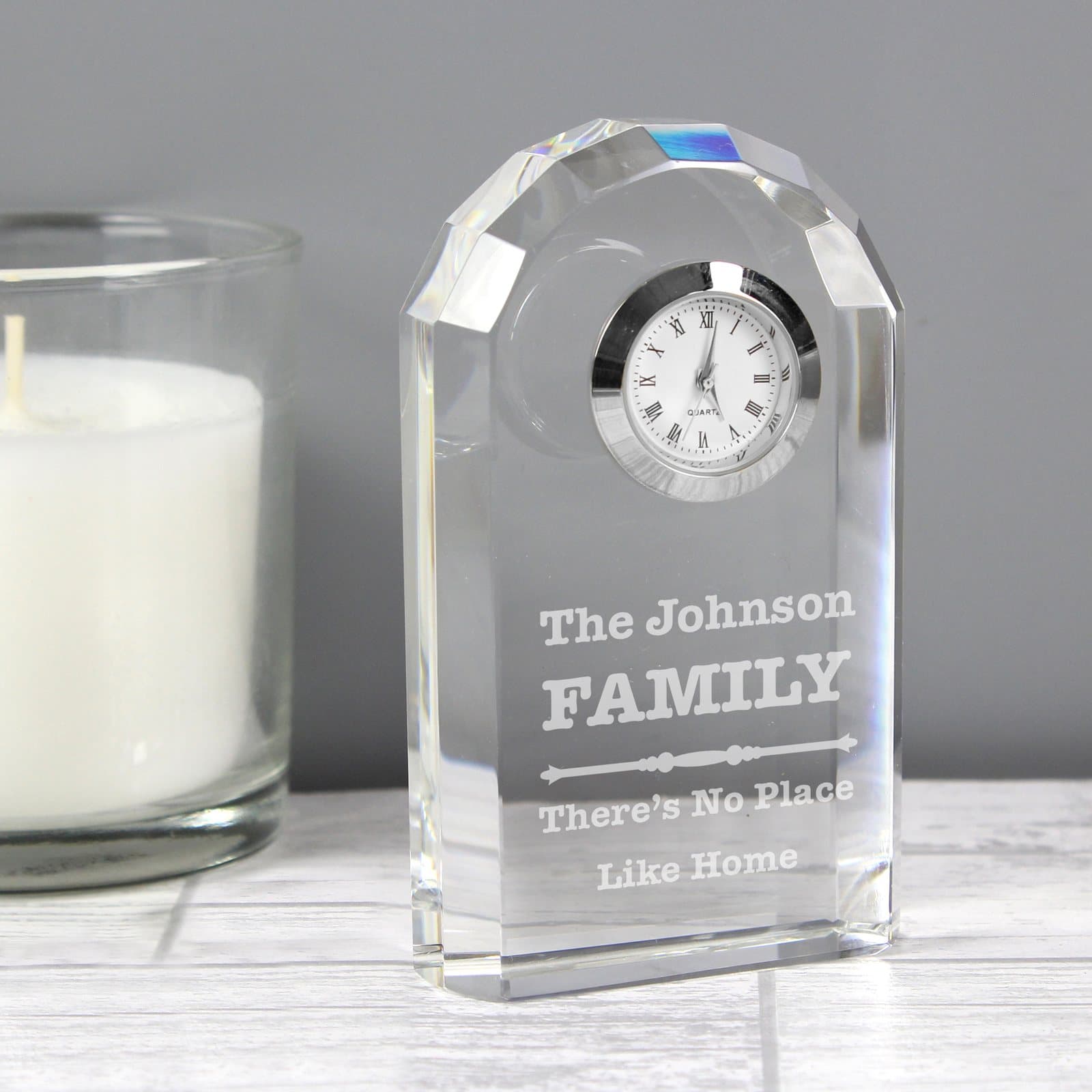 Crystal clock with a scroll design and engraved lines of text