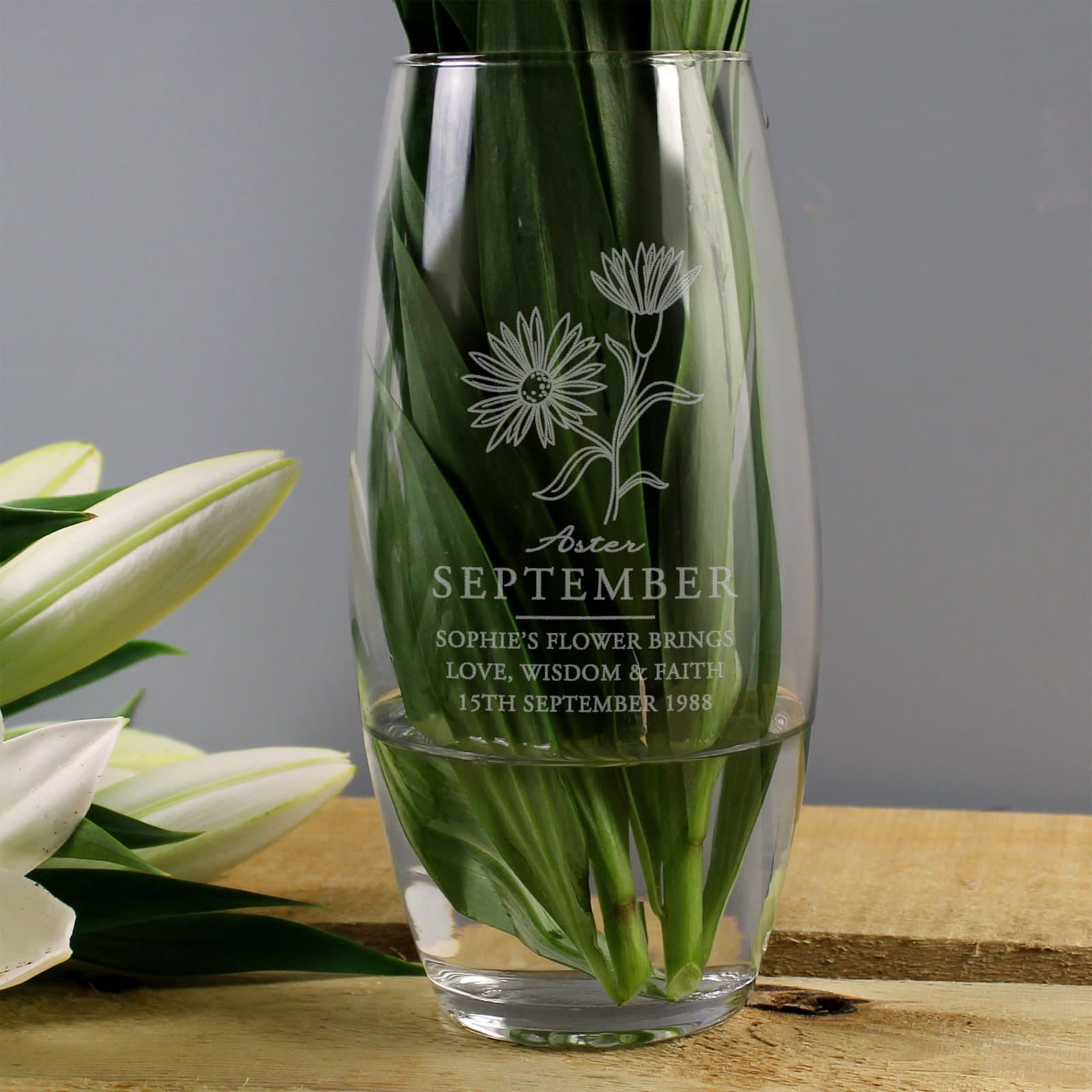Glass bullet vase with a September aster illustration